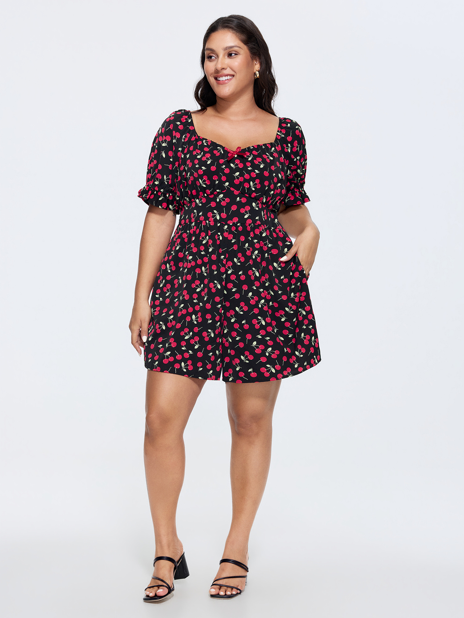 Side view of BloomChic Women's Plus Size Cherry Print Puffy Sleeve Lace Romper Black Elegant Fitted 14-16/1X