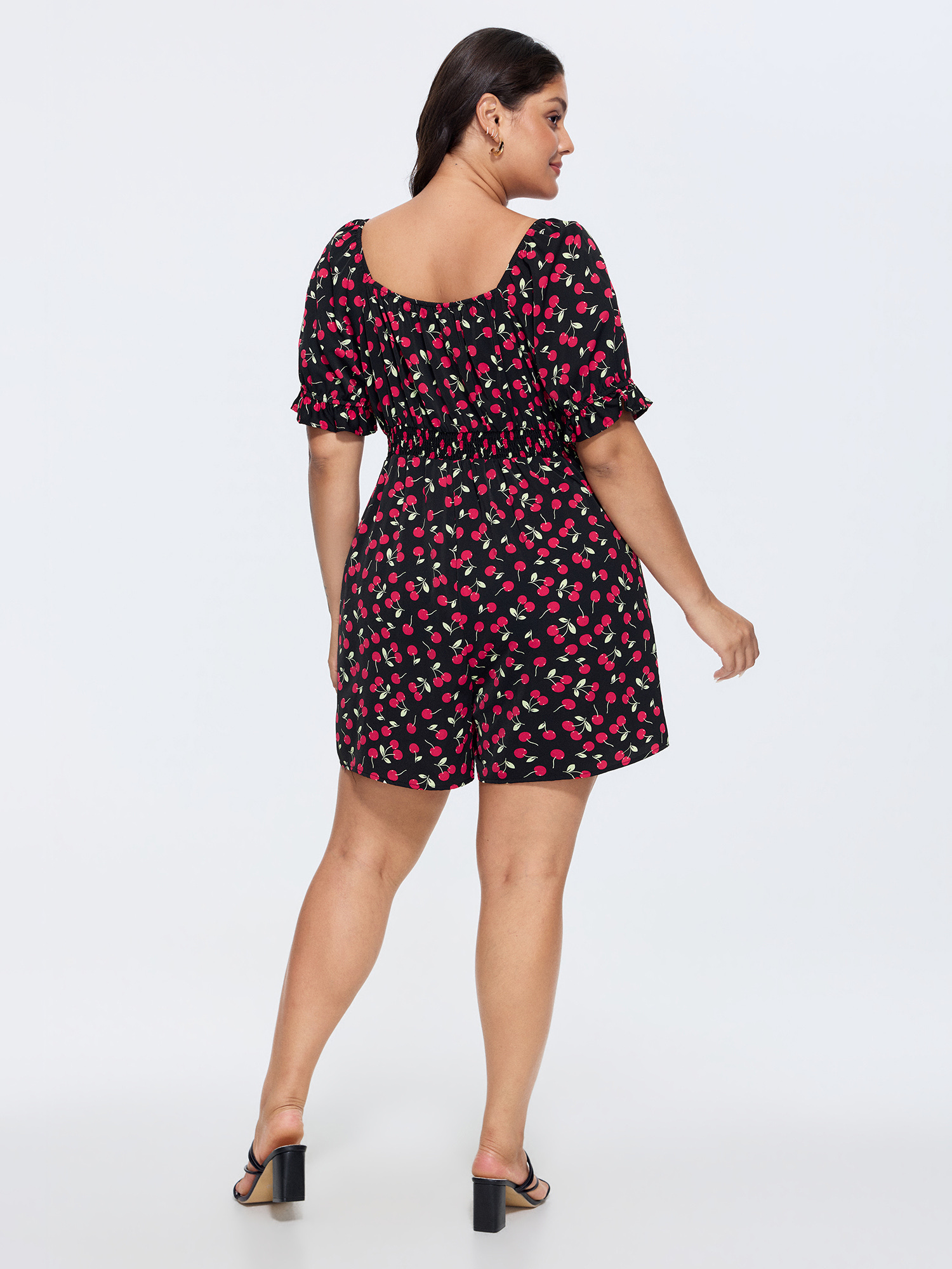 Side view of BloomChic Women's Plus Size Cherry Print Puffy Sleeve Lace Romper Black Elegant Fitted 14-16/1X