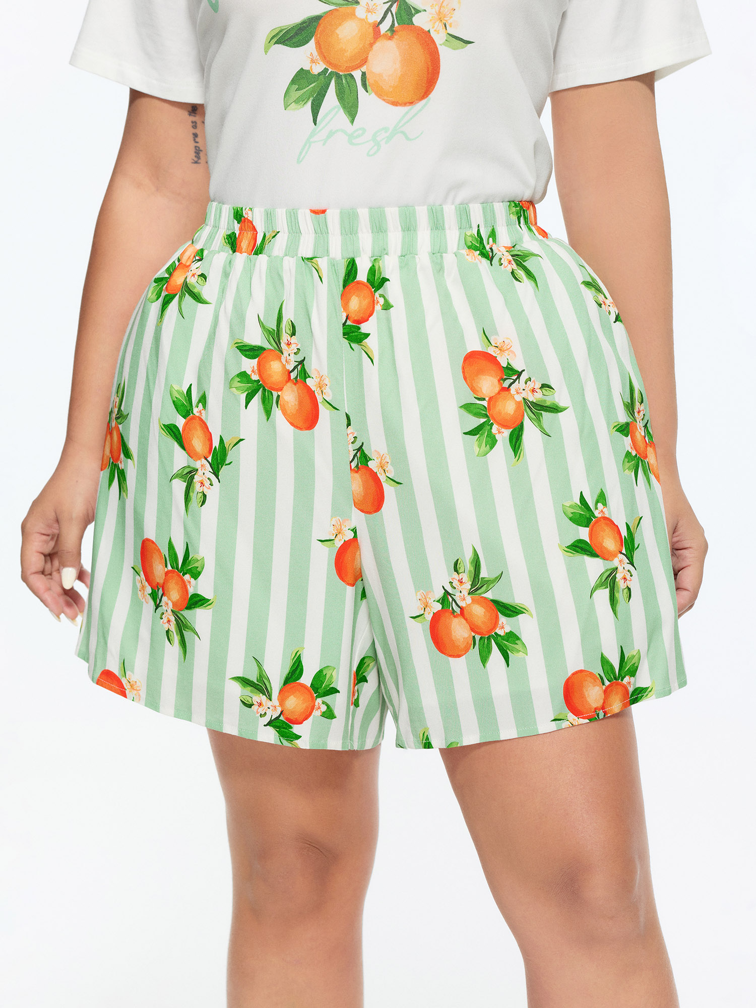 Side view of BloomChic Women's Plus Size Citrus Print Stretchy Lounge Set Greenbean Fruit Short sleeve Smocked 26/4X