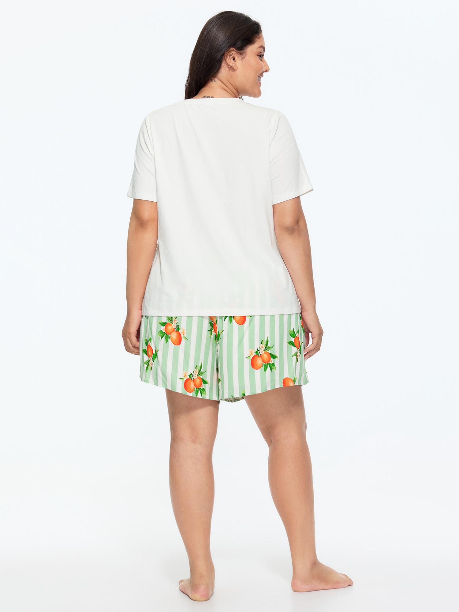 Side view of BloomChic Women's Plus Size Citrus Print Stretchy Lounge Set Greenbean Fruit Short sleeve Smocked 26/4X