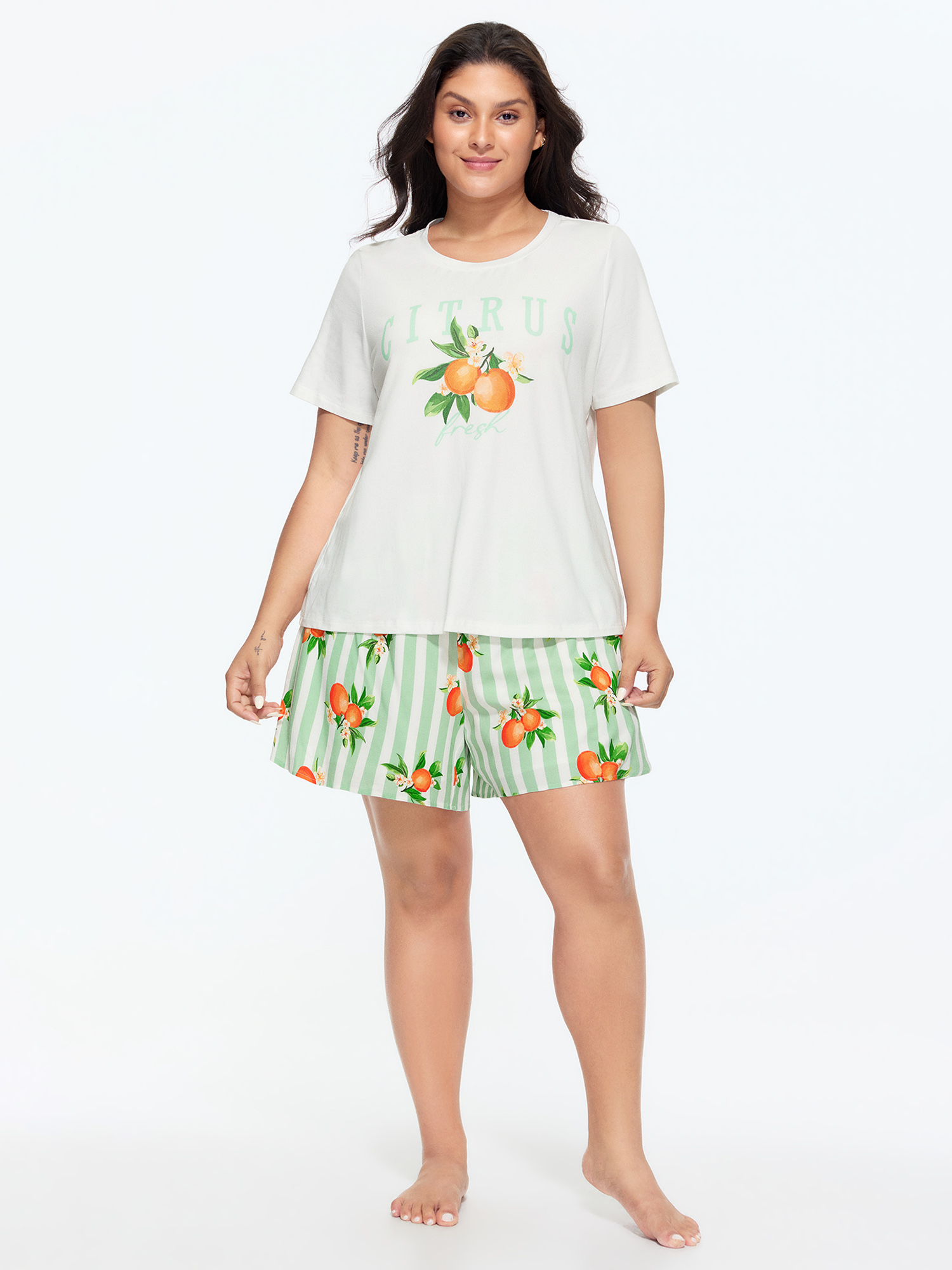 Side view of BloomChic Women's Plus Size Citrus Print Stretchy Lounge Set Greenbean Fruit Short sleeve Smocked 26/4X
