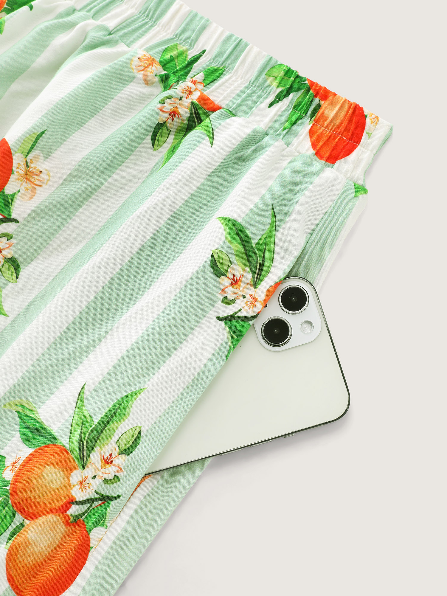 Side view of BloomChic Women's Plus Size Citrus Print Stretchy Lounge Set Greenbean Fruit Short sleeve Smocked 26/4X