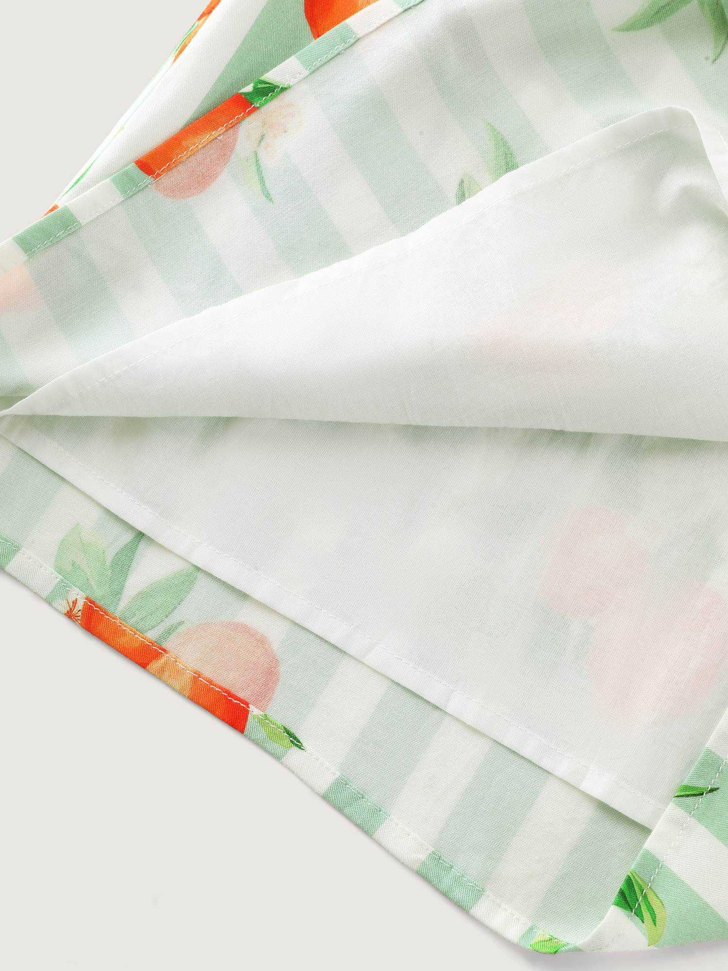 Side view of BloomChic Women's Plus Size Citrus Print Stretchy Lounge Set Greenbean Fruit Short sleeve Smocked 26/4X