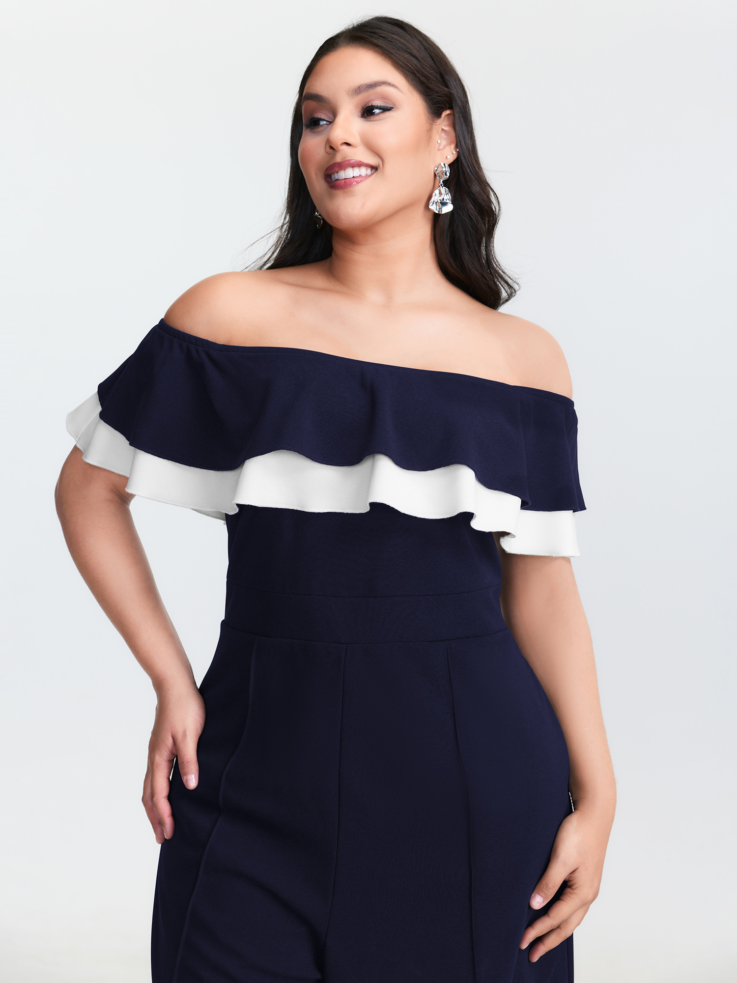 Side view of BloomChic Women's Plus Size Off-Shoulder Lotus Leaf Neckline Jumpsuit DarkBlue Elegant Fitted 12/L