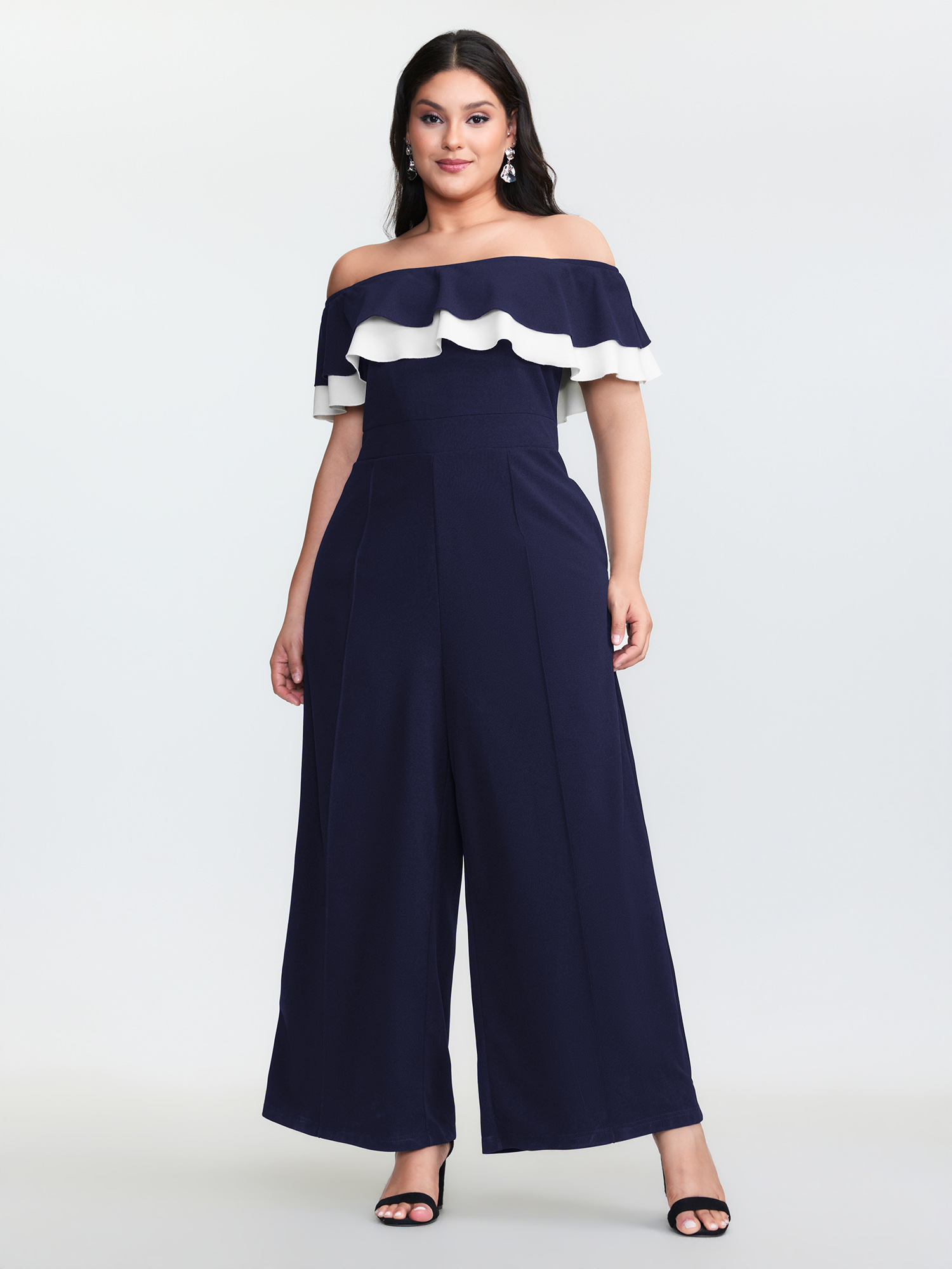 Side view of BloomChic Women's Plus Size Off-Shoulder Lotus Leaf Neckline Jumpsuit DarkBlue Elegant Fitted 12/L