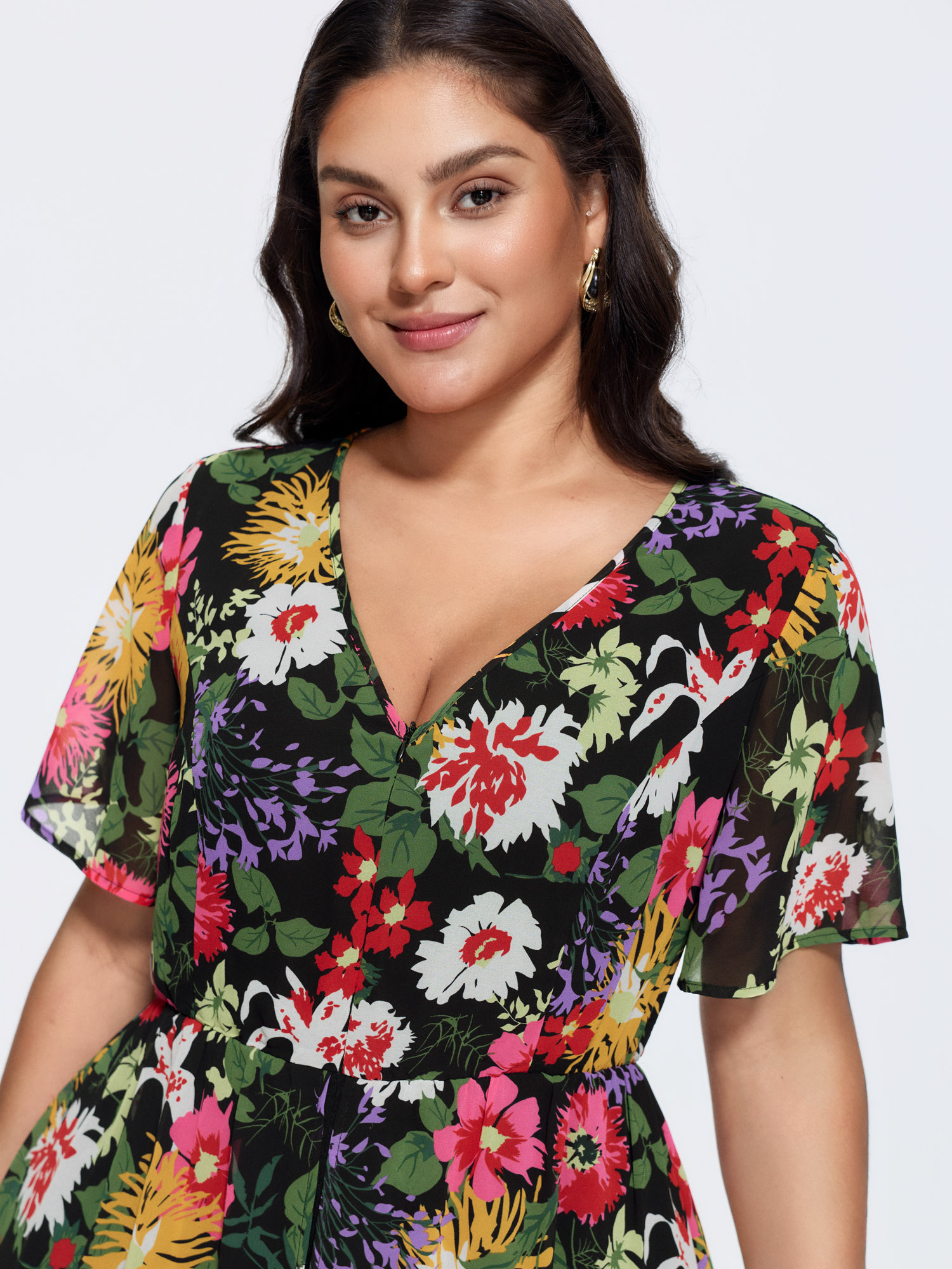 Side view of BloomChic Women's Plus Size Hidden Zipper Floral Layered Pockets Jumpsuit Black Elegant 10/M