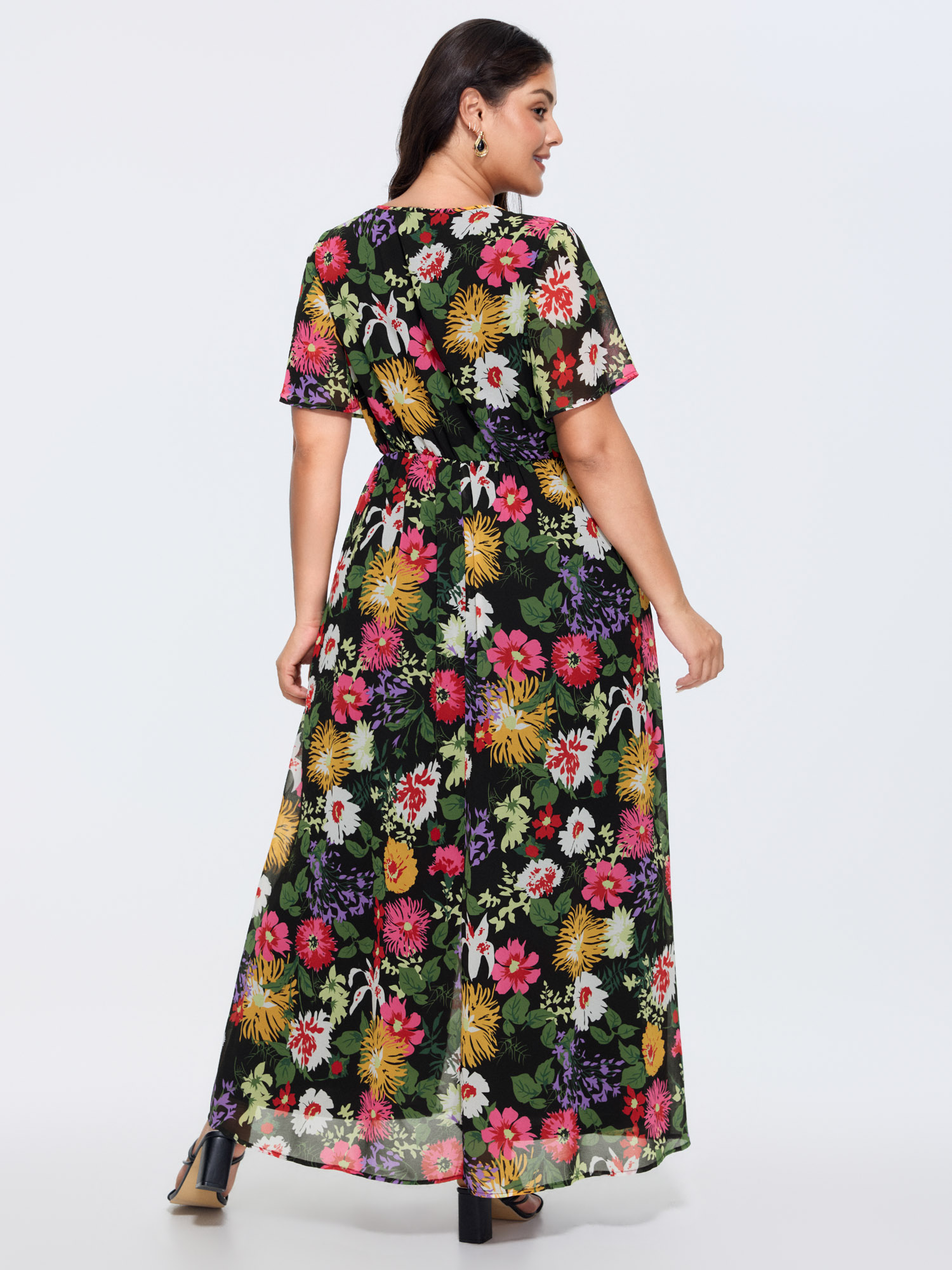 Side view of BloomChic Women's Plus Size Hidden Zipper Floral Layered Pockets Jumpsuit Black Elegant 10/M
