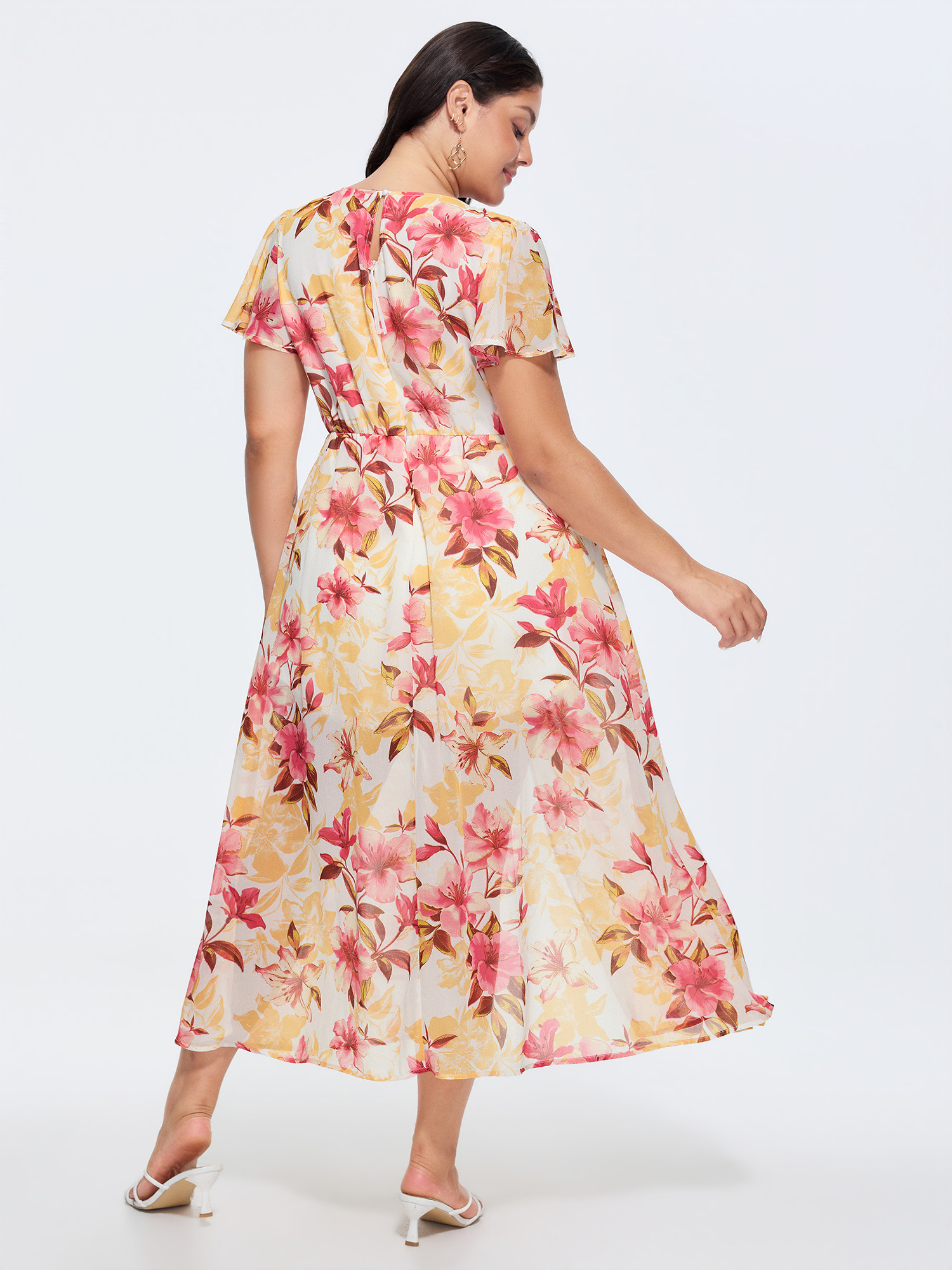 Side view of BloomChic Women's Plus Size Floral Print Stretchy Layered Jumpsuit MistyRose Elegant Fitted 28/5X
