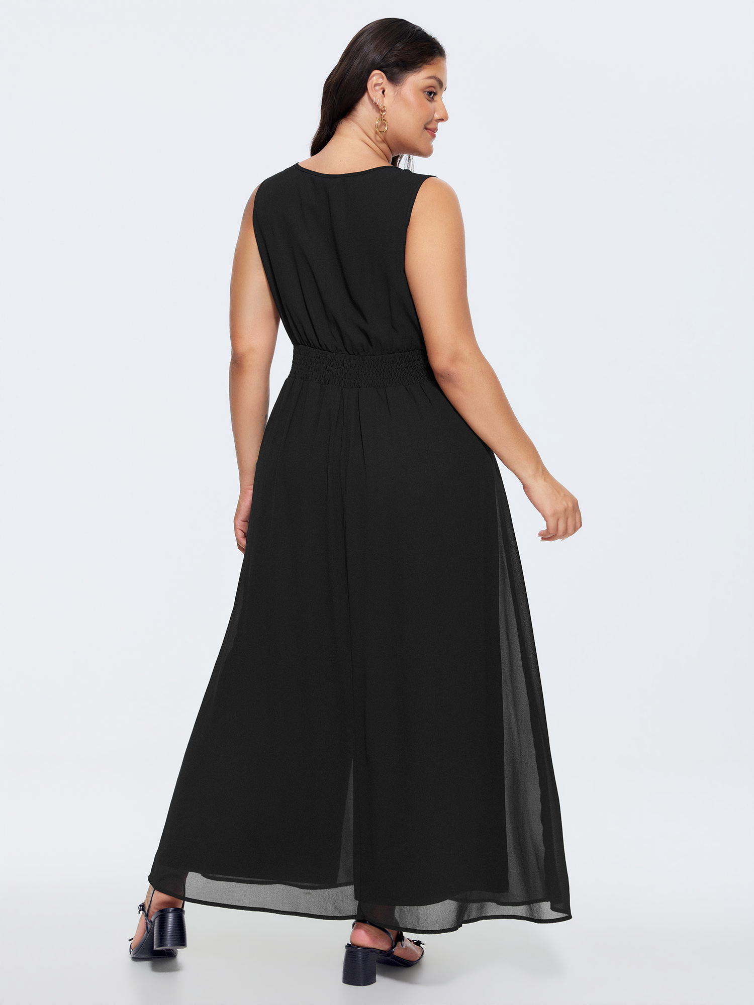 Side view of BloomChic Women's Plus Size Layered Mesh Flowy Jumpsuit Black Elegant Fitted 12/L