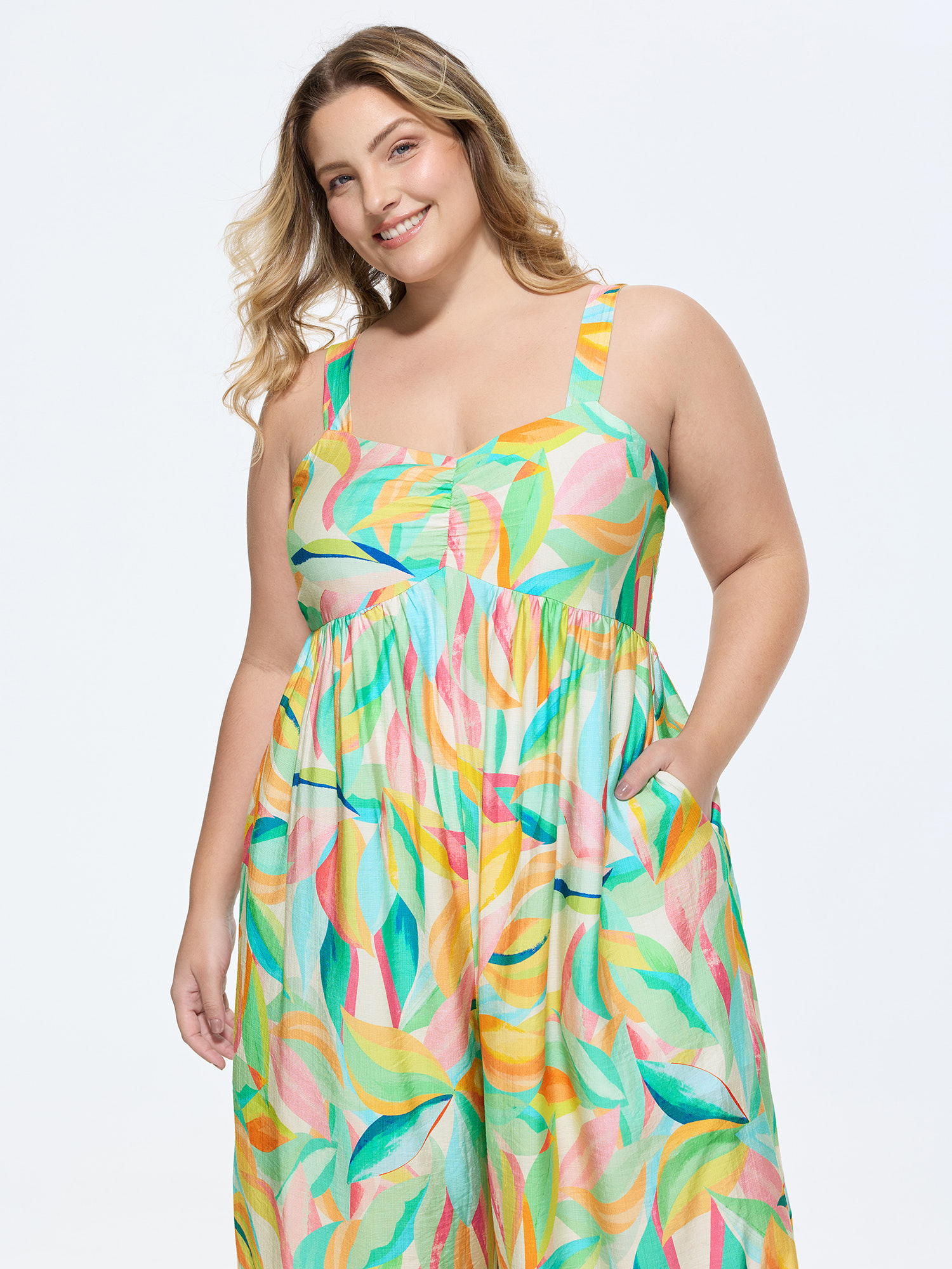 Side view of BloomChic Women's Plus Size Colorful Floral Print Ruched Jumpsuit Arctic Casual 10/M