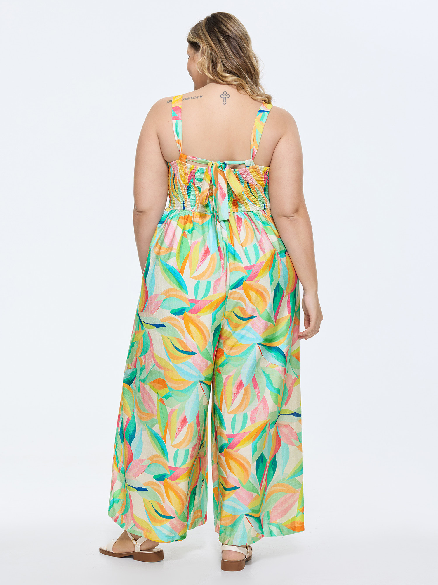 Side view of BloomChic Women's Plus Size Colorful Floral Print Ruched Jumpsuit Arctic Casual 10/M