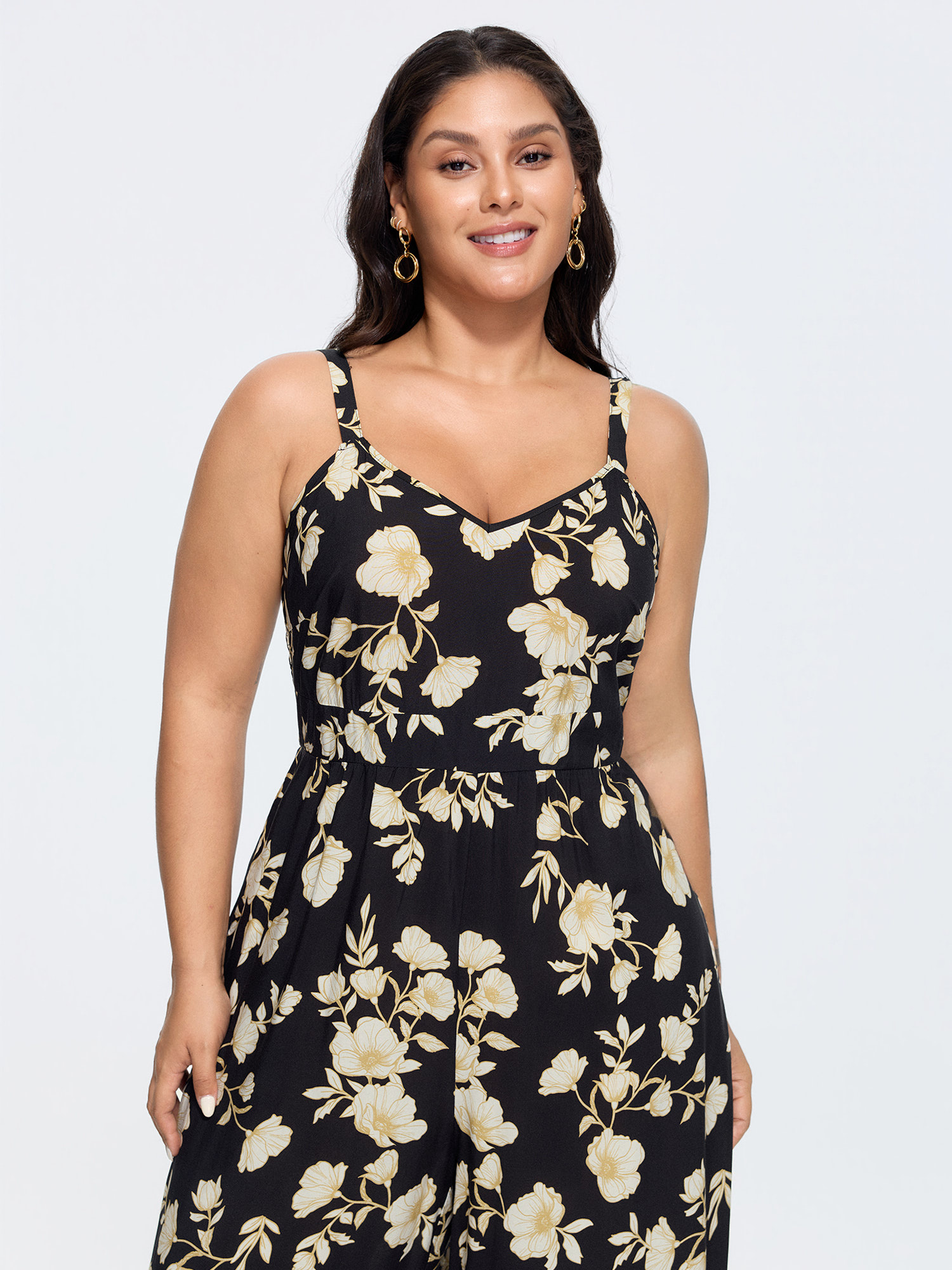 Side view of BloomChic Women's Plus Size Floral Print Shirred Back Jumpsuit Black Elegant Relaxed Fit 12/L
