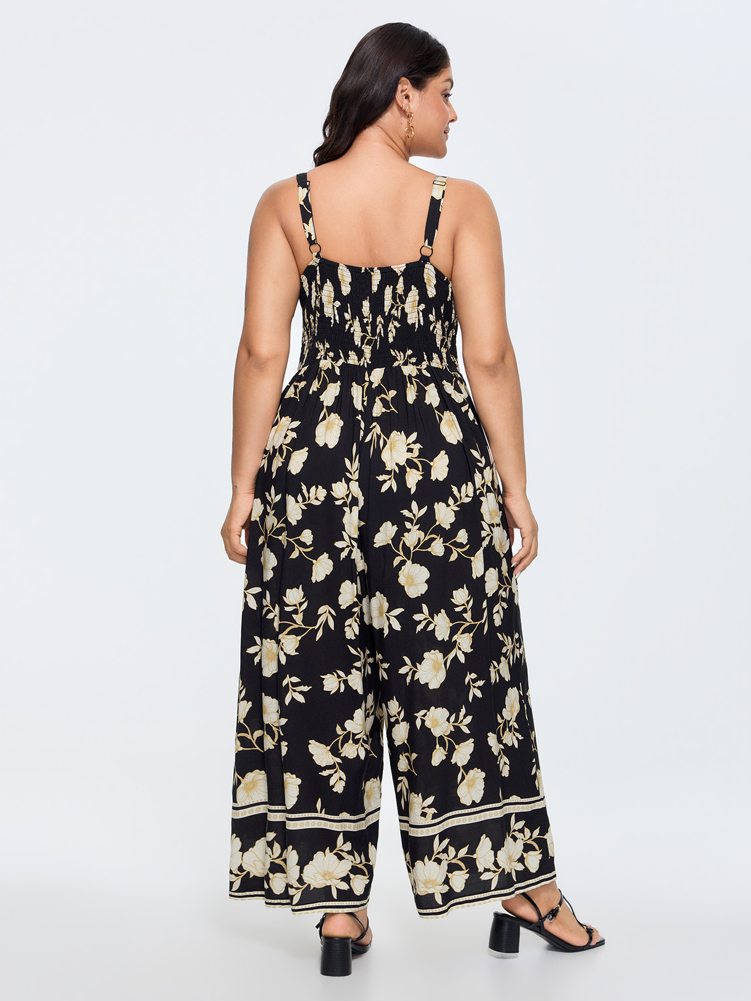 Side view of BloomChic Women's Plus Size Floral Print Shirred Back Jumpsuit Black Elegant Relaxed Fit 12/L