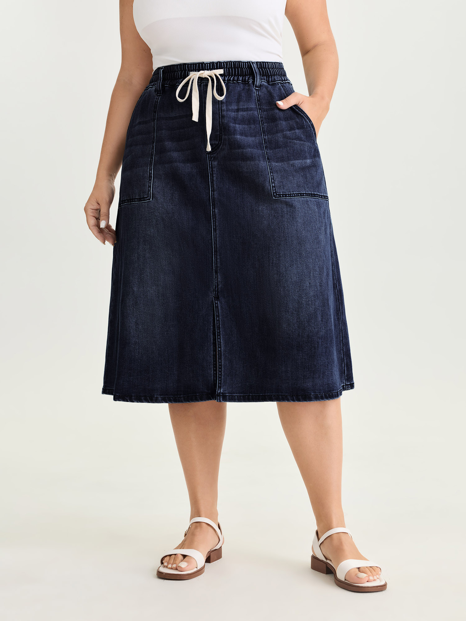 Side view of BloomChic Women's Plus Size Stretchy Contrast Drawstring Waist Midi Denim Skirt Denimindigo 18-20/2X