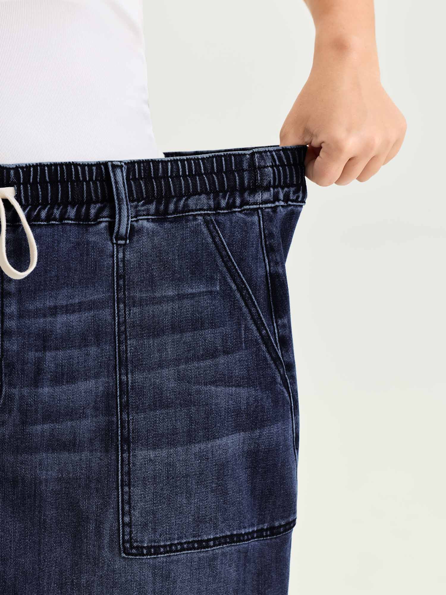 Side view of BloomChic Women's Plus Size Stretchy Contrast Drawstring Waist Midi Denim Skirt Denimindigo 18-20/2X