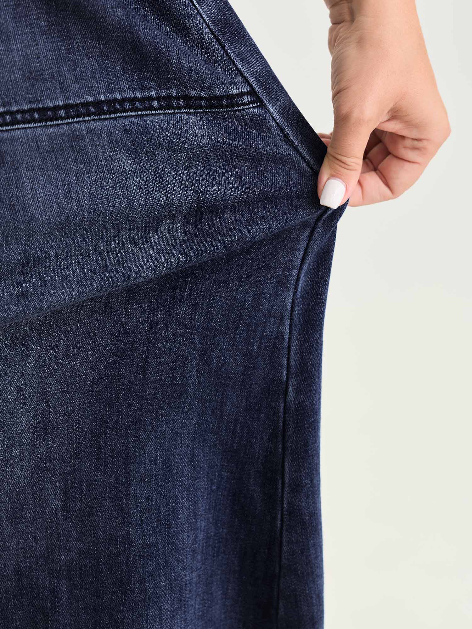 Side view of BloomChic Women's Plus Size Stretchy Contrast Drawstring Waist Midi Denim Skirt Denimindigo 18-20/2X