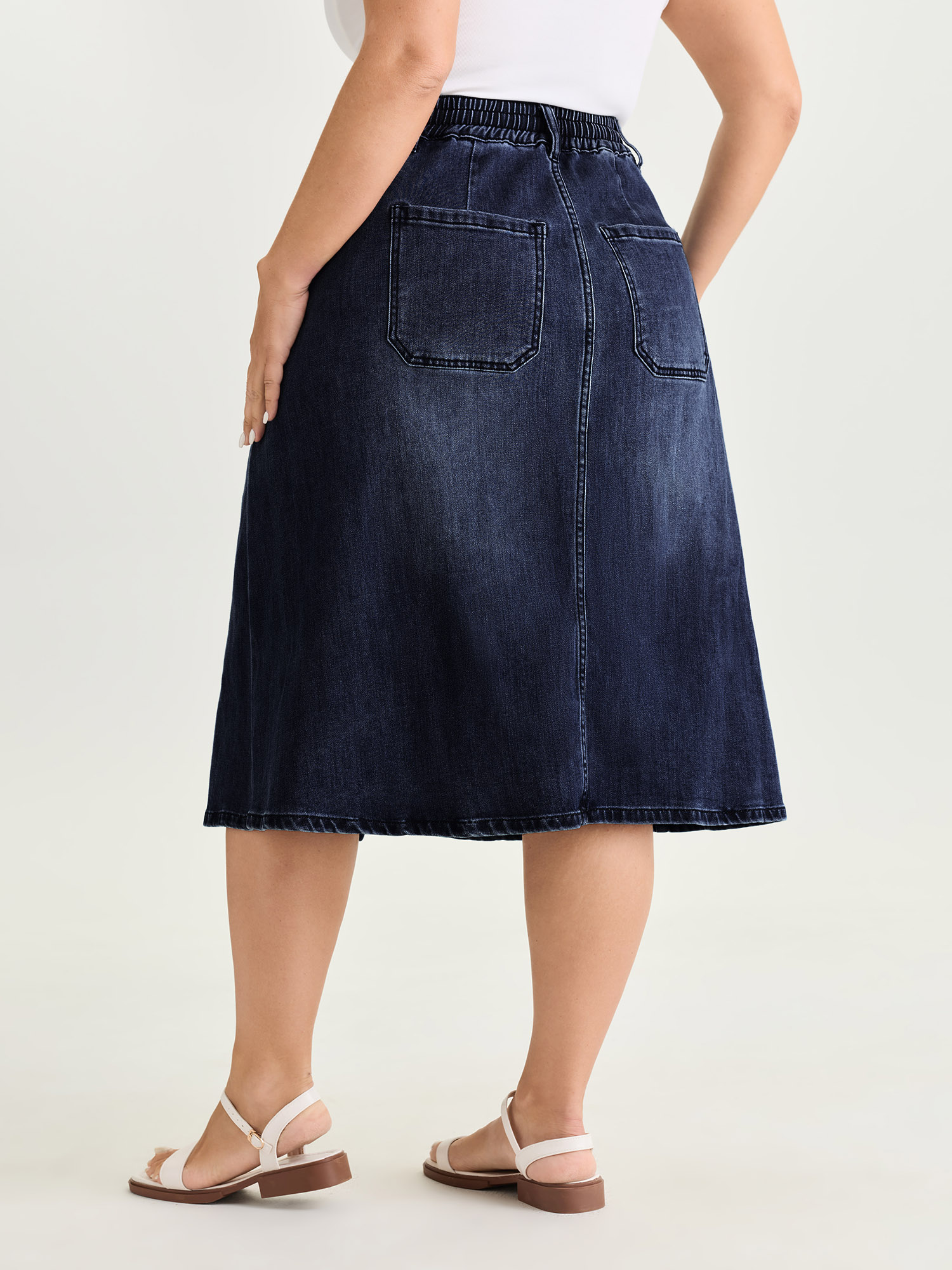 Side view of BloomChic Women's Plus Size Stretchy Contrast Drawstring Waist Midi Denim Skirt Denimindigo 18-20/2X