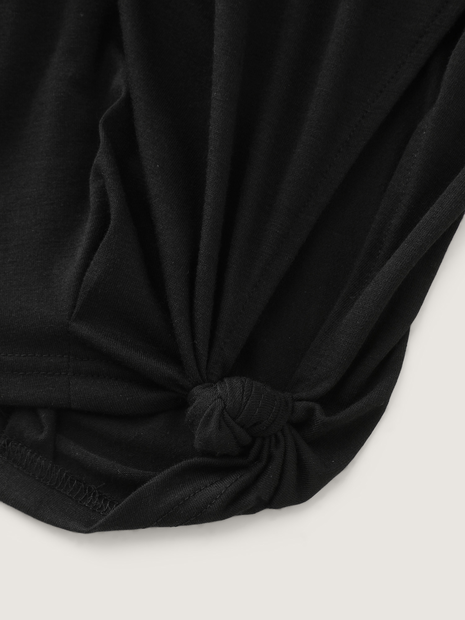 Side view of BloomChic Women's Plus Size Supersoft Stretchy Cuffed Cropped Lounge Bottoms Black Capri 14-16/1X