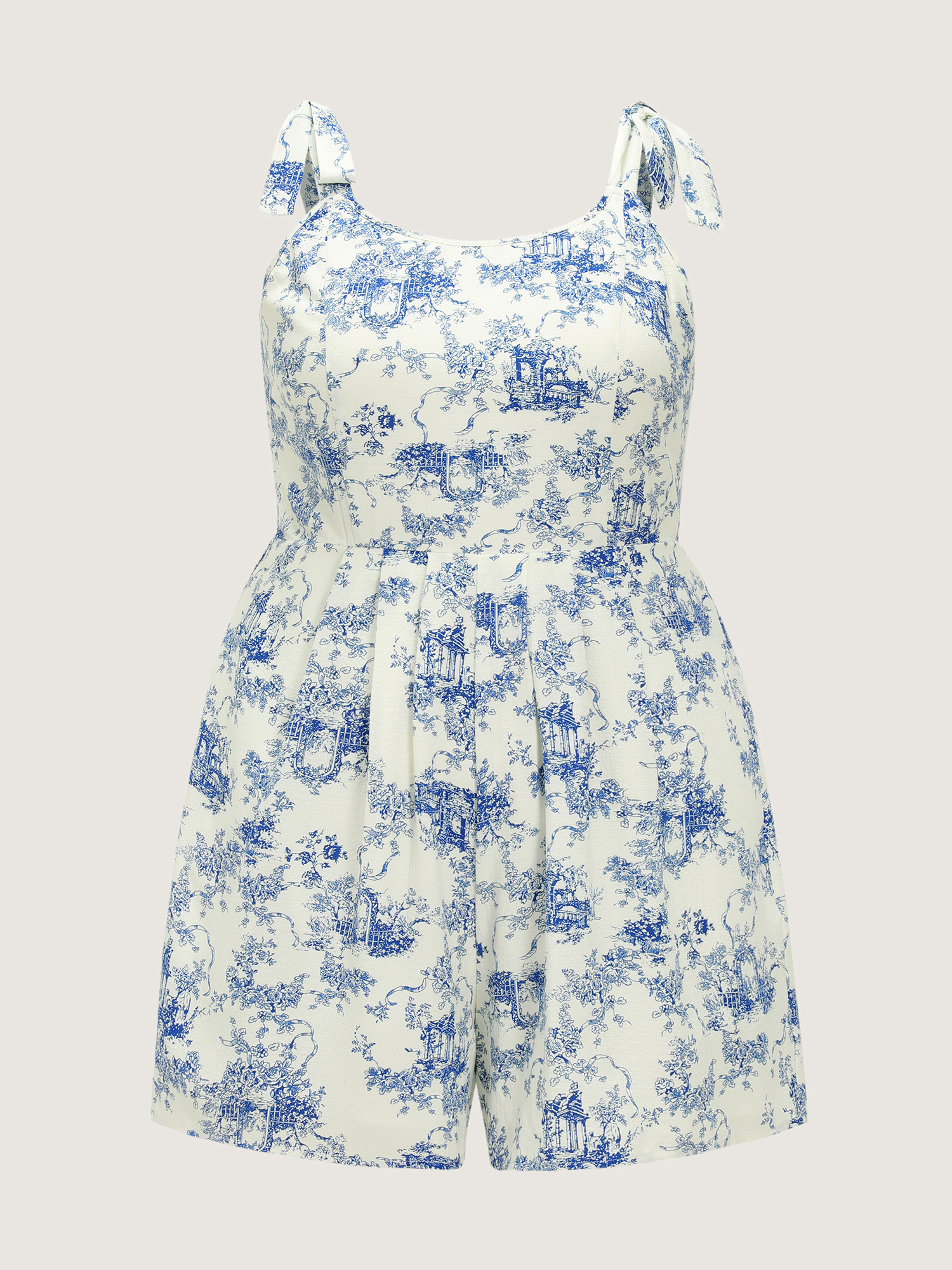 Side view of BloomChic Women's Plus Size Garden Print Adjustable Shoulder-Tie Romper Indigo Vacation 22-24/3X