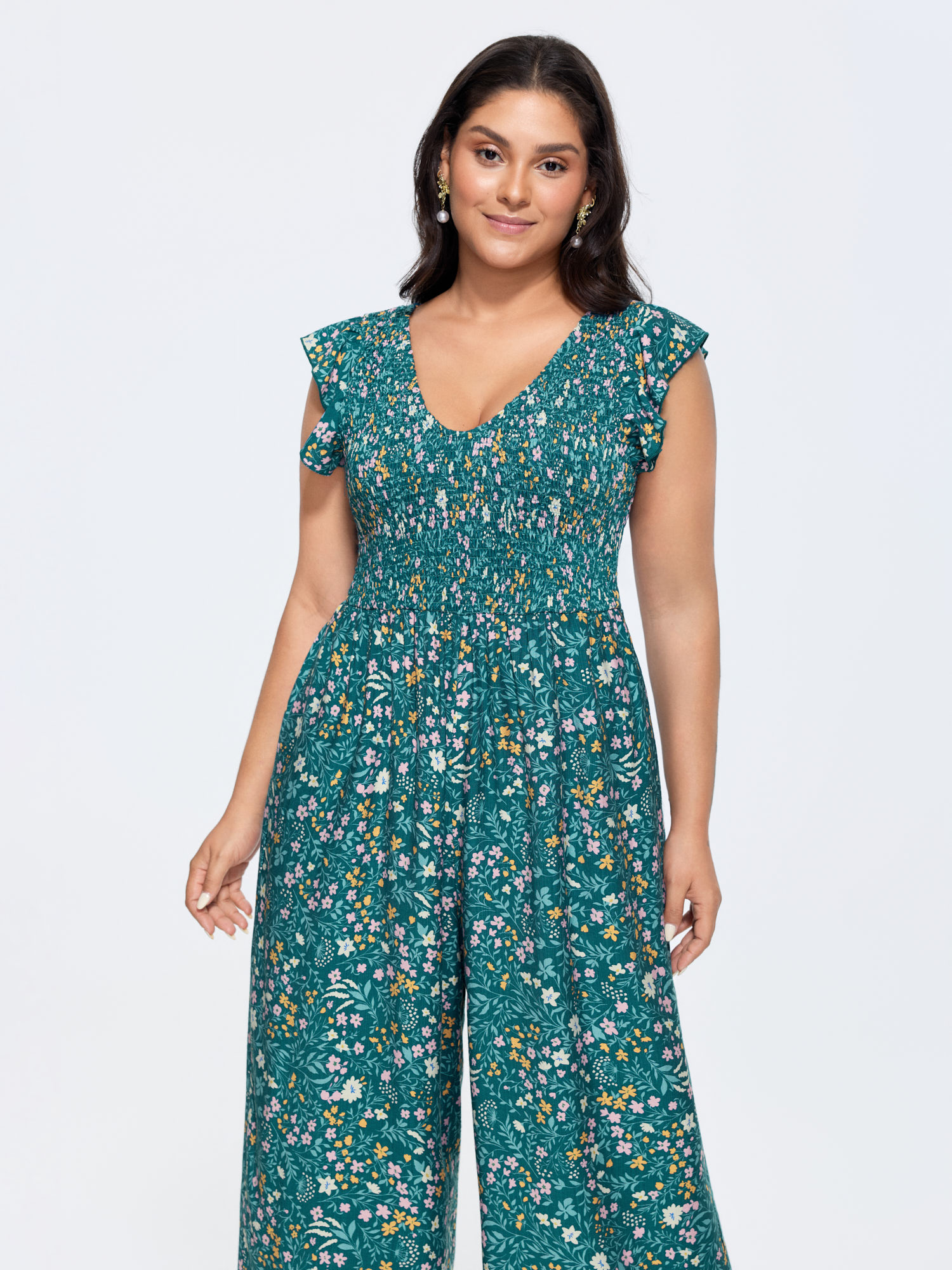 Side view of BloomChic Women's Plus Size Breezy Floral Print Flutter Sleeve Jumpsuit Mediumblue Elegant 26/4X
