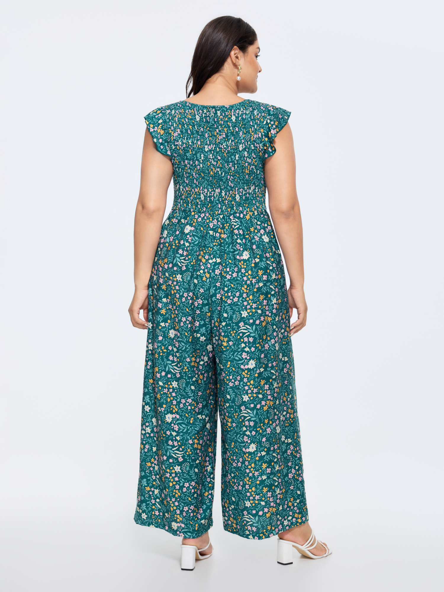 Side view of BloomChic Women's Plus Size Breezy Floral Print Flutter Sleeve Jumpsuit Mediumblue Elegant 26/4X