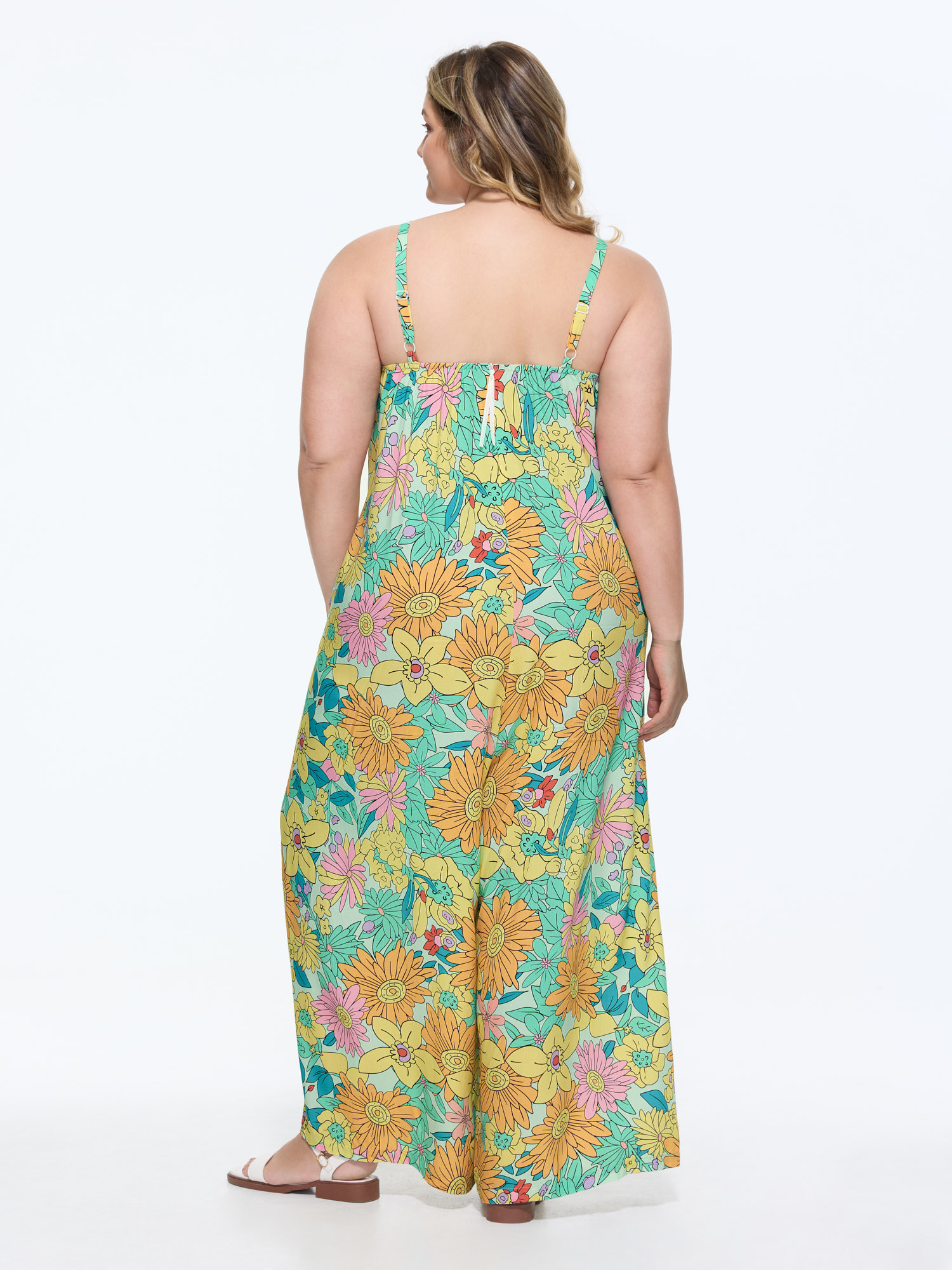 Side view of BloomChic Women's Plus Size Vivid Groove Stretchy Adjustable Jumpsuit Gold Casual Fitted 10/M