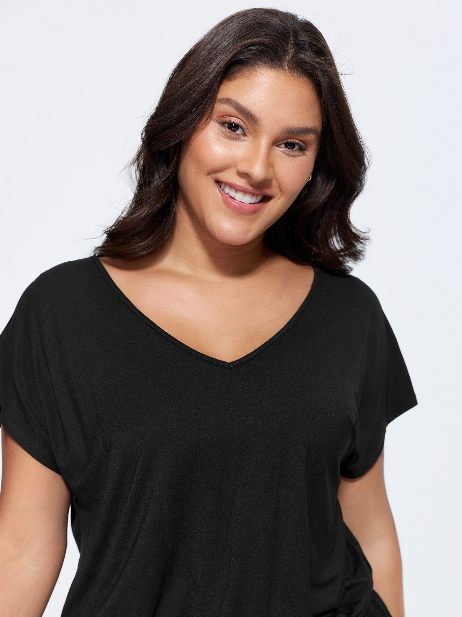 Side view of BloomChic Women's Plus Size Supersoft V-Neck Drawstring Romper Black Casual 10/M