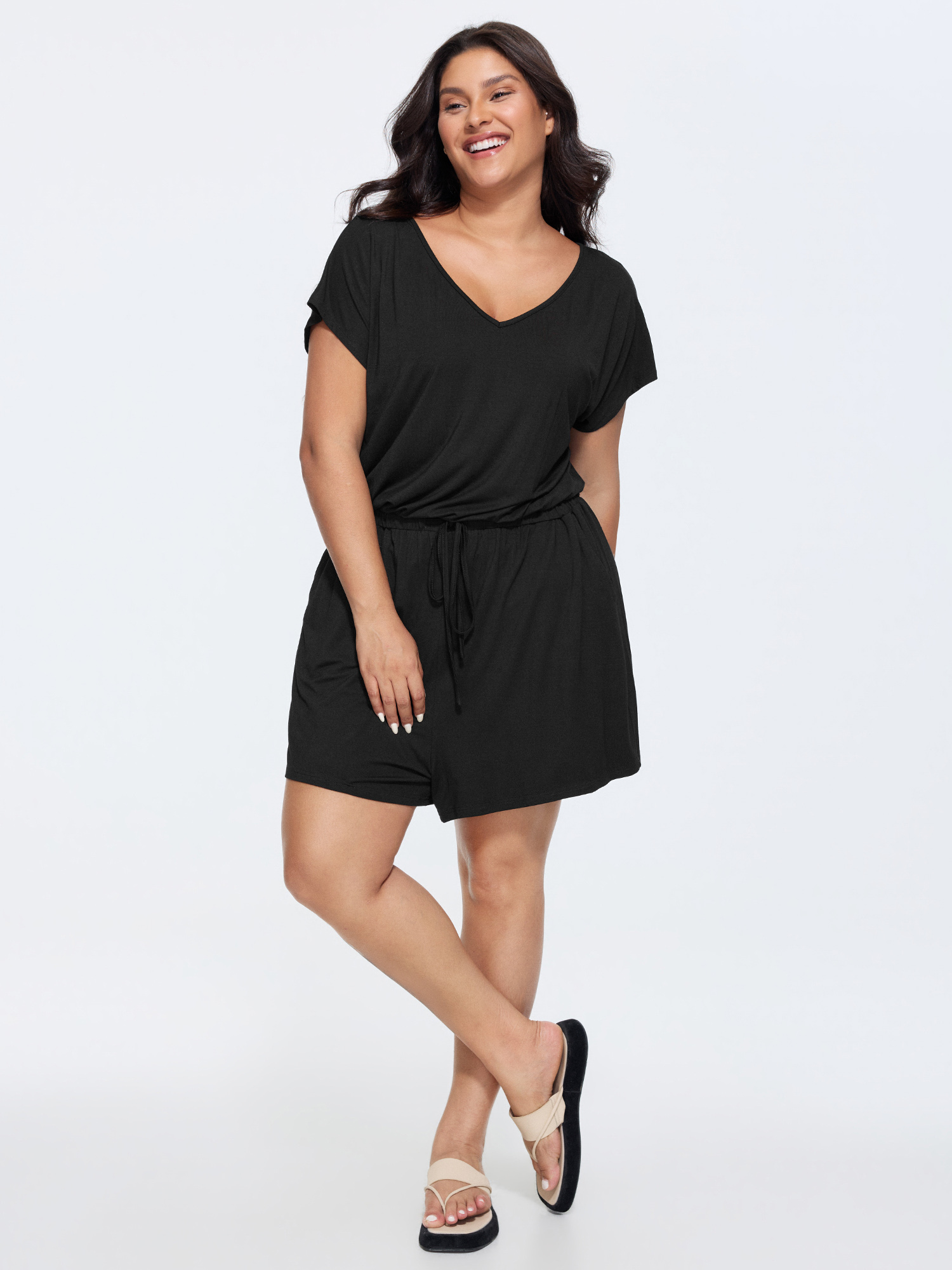 Side view of BloomChic Women's Plus Size Supersoft V-Neck Drawstring Romper Black Casual 10/M