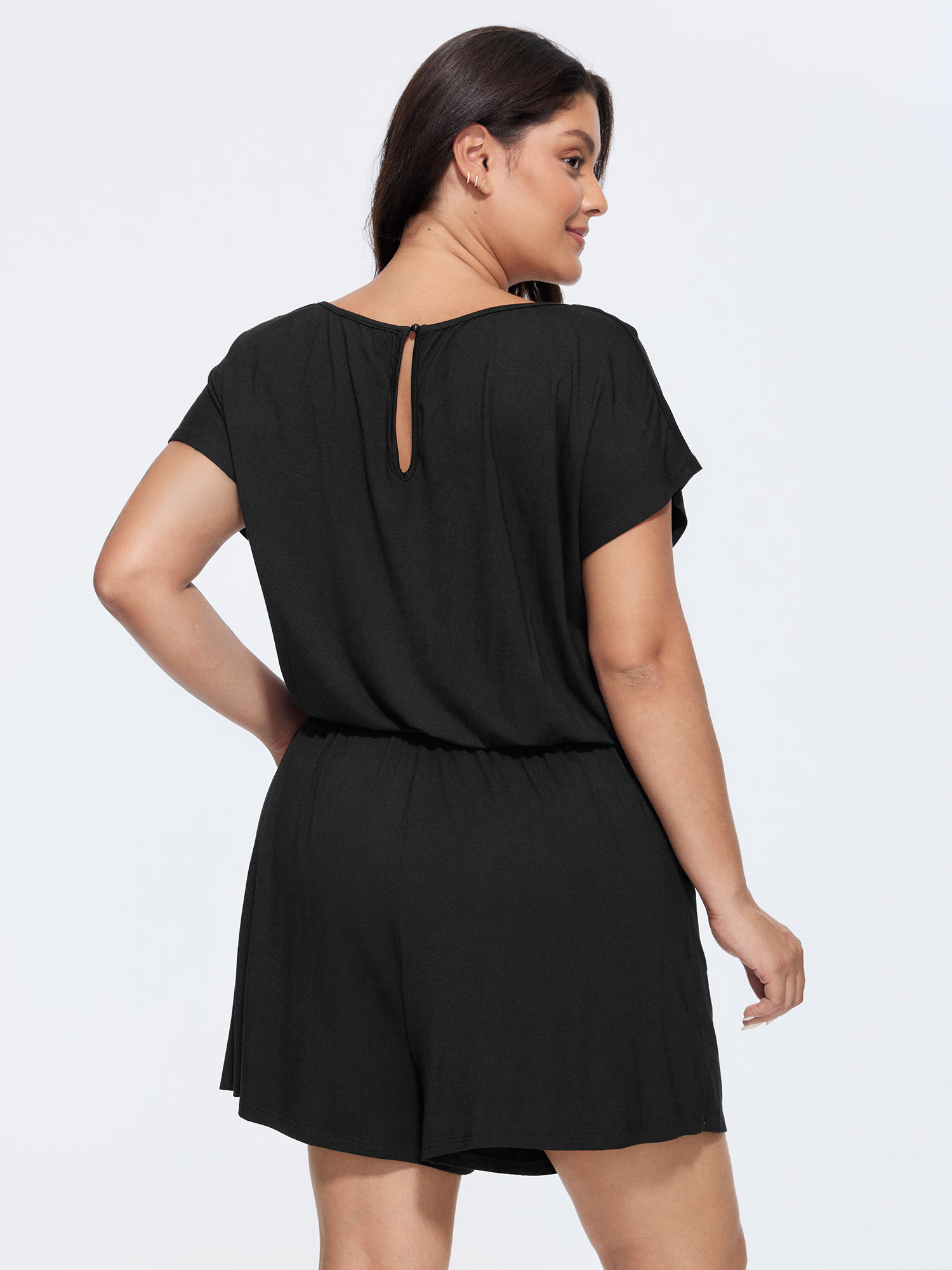 Side view of BloomChic Women's Plus Size Supersoft V-Neck Drawstring Romper Black Casual 10/M