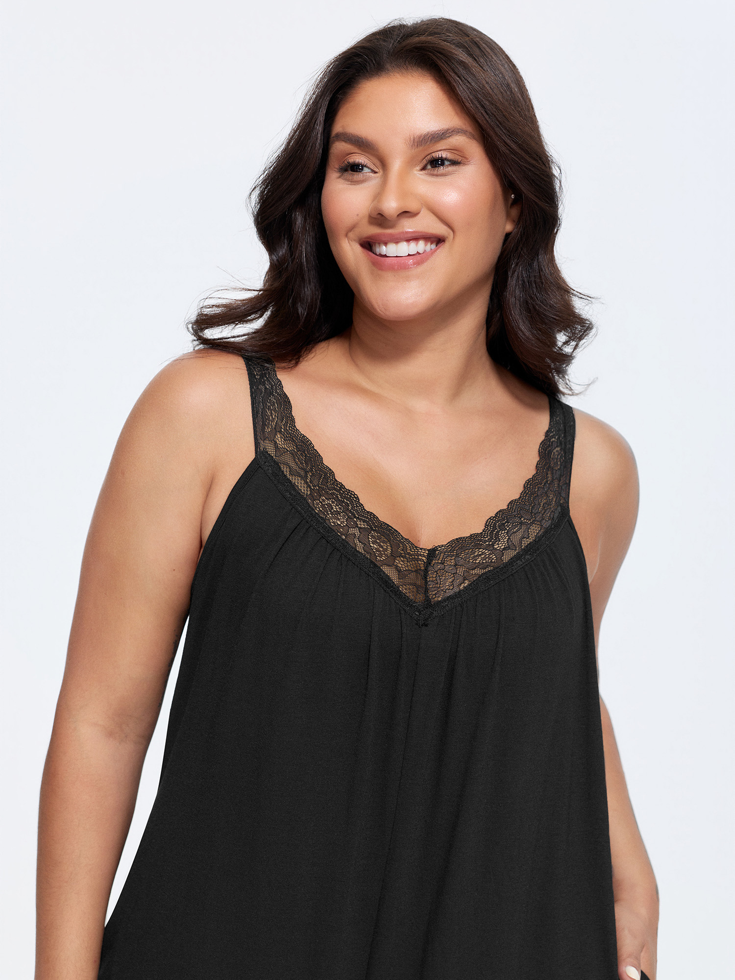 Side view of BloomChic Women's Plus Size Supersoft Stretchy Sheer Neckline Relaxed-Fit Lounge Jumpsuit Black not graphics 14-16/1X