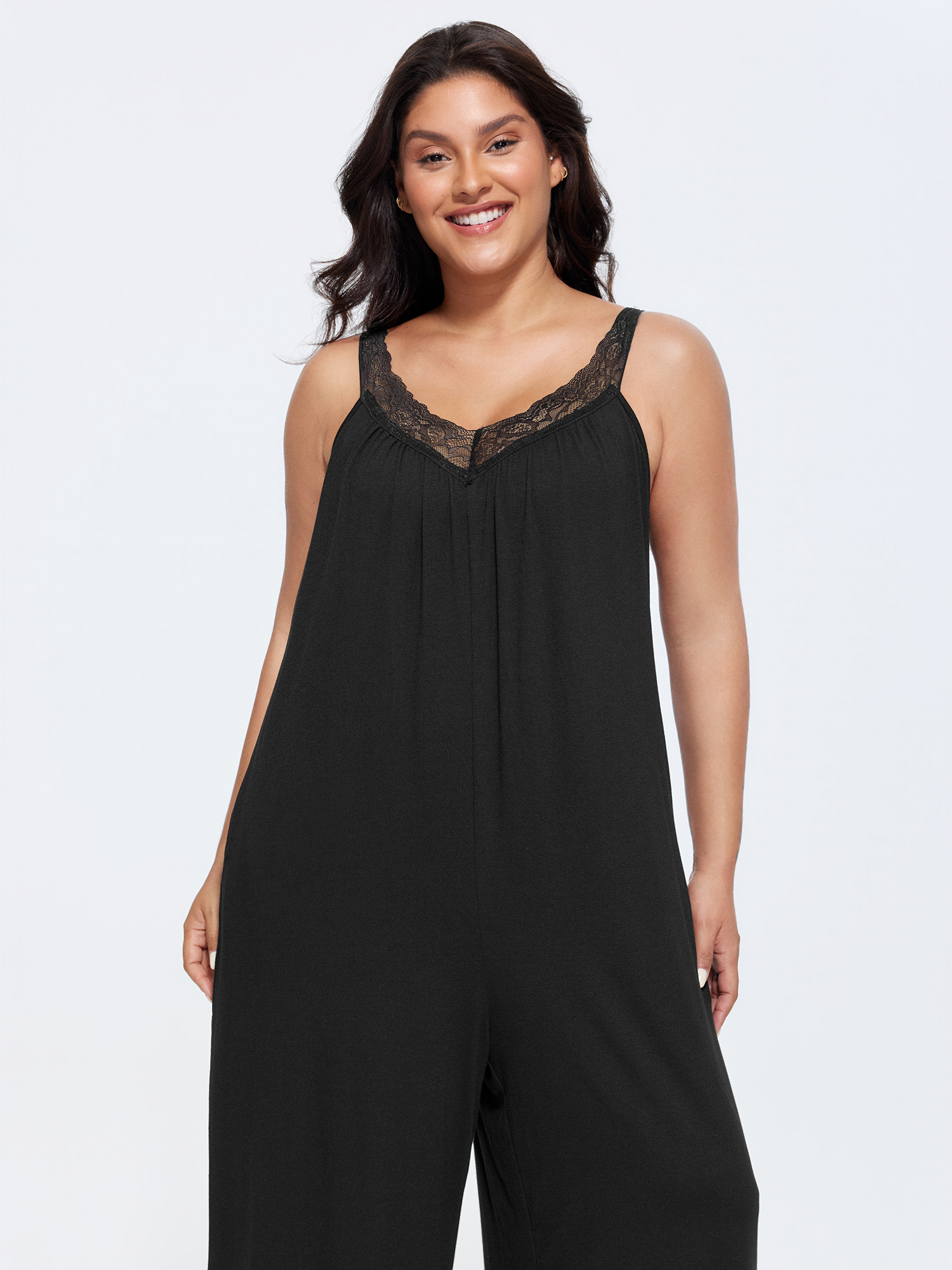 Side view of BloomChic Women's Plus Size Supersoft Stretchy Sheer Neckline Relaxed-Fit Lounge Jumpsuit Black not graphics 14-16/1X