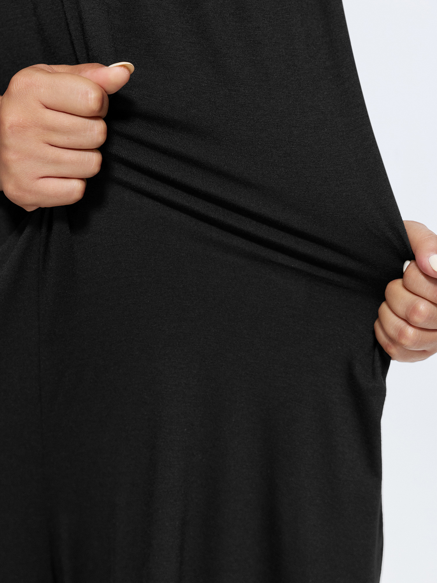 Side view of BloomChic Women's Plus Size Supersoft Stretchy Sheer Neckline Relaxed-Fit Lounge Jumpsuit Black not graphics 14-16/1X