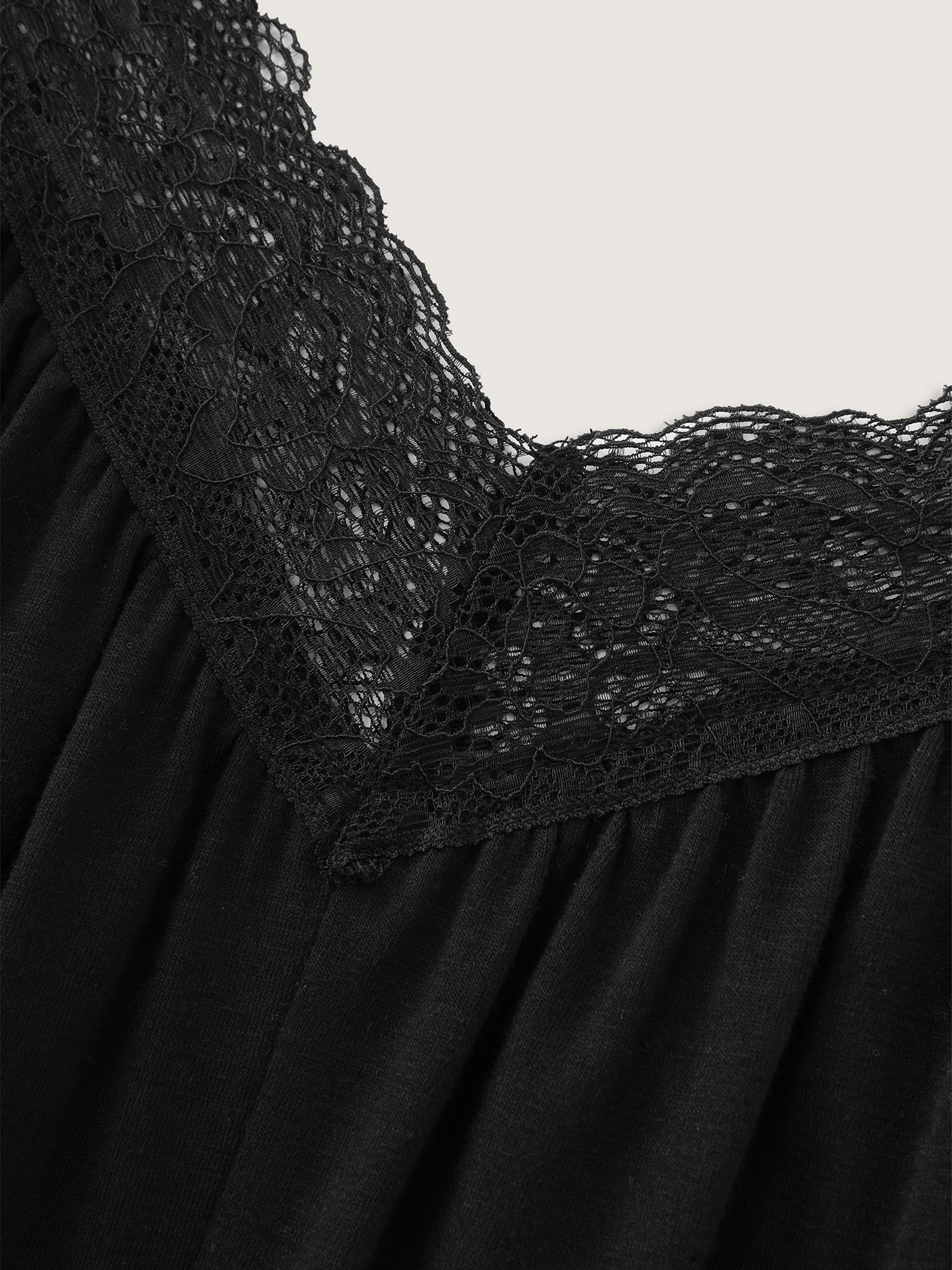 Side view of BloomChic Women's Plus Size Supersoft Stretchy Sheer Neckline Relaxed-Fit Lounge Jumpsuit Black not graphics 14-16/1X
