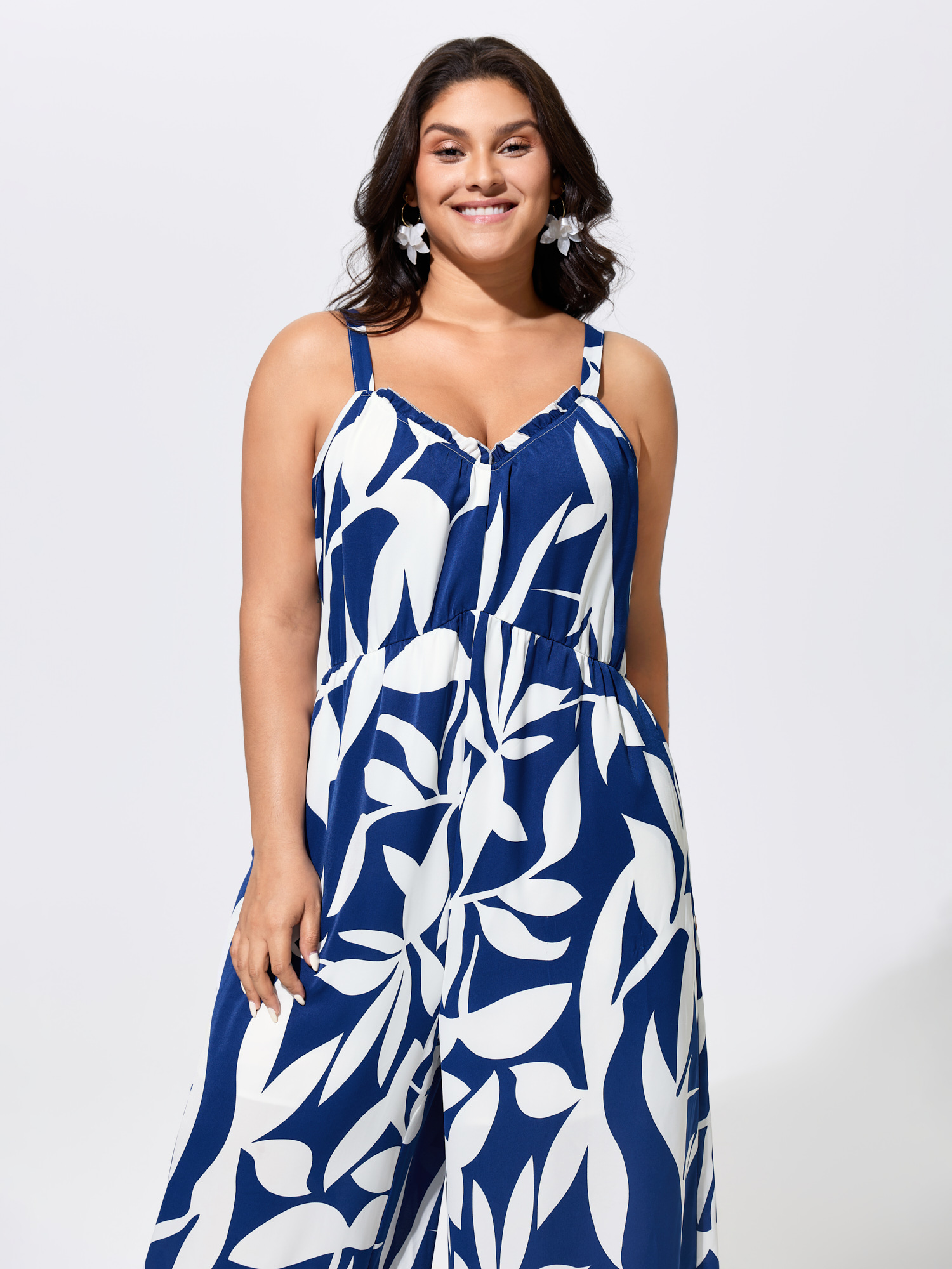 Side view of BloomChic Women's Plus Size Silhouette Floral Print Sweetheart Jumpsuit Indigo Vacation 22-24/3X