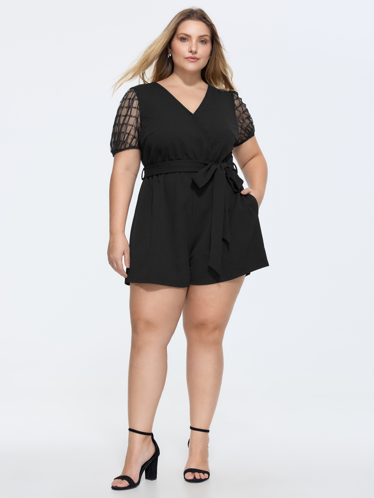 Side view of BloomChic Women's Plus Size Sheer Sleeves Waist-Tie Romper Pureblack Office 14-16/1X