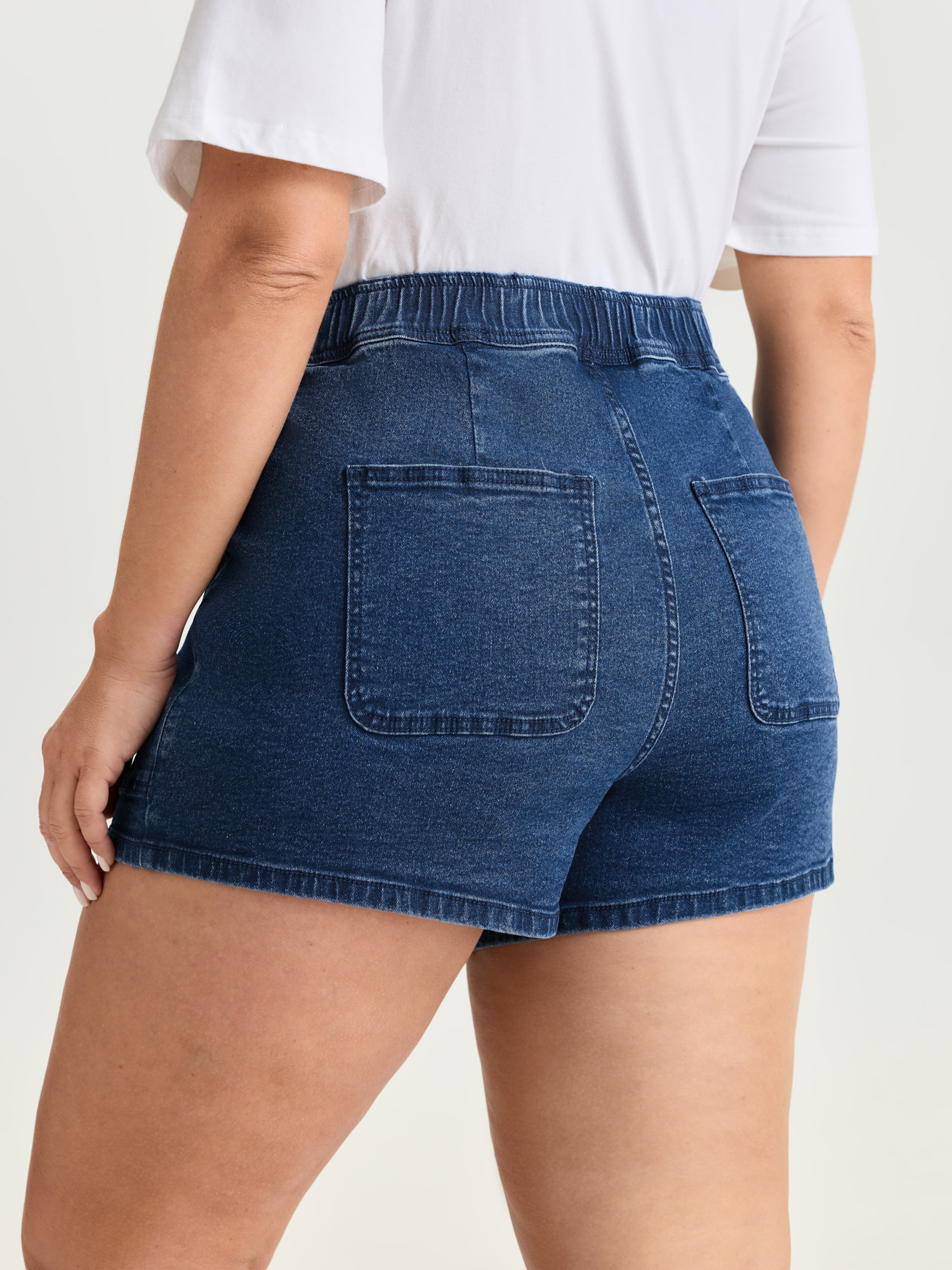 Side view of BloomChic Women's Plus Size Stretchy Pull-On Straight-Leg Denim Shorts Denimindigo Non High Rise Casual 30/6X