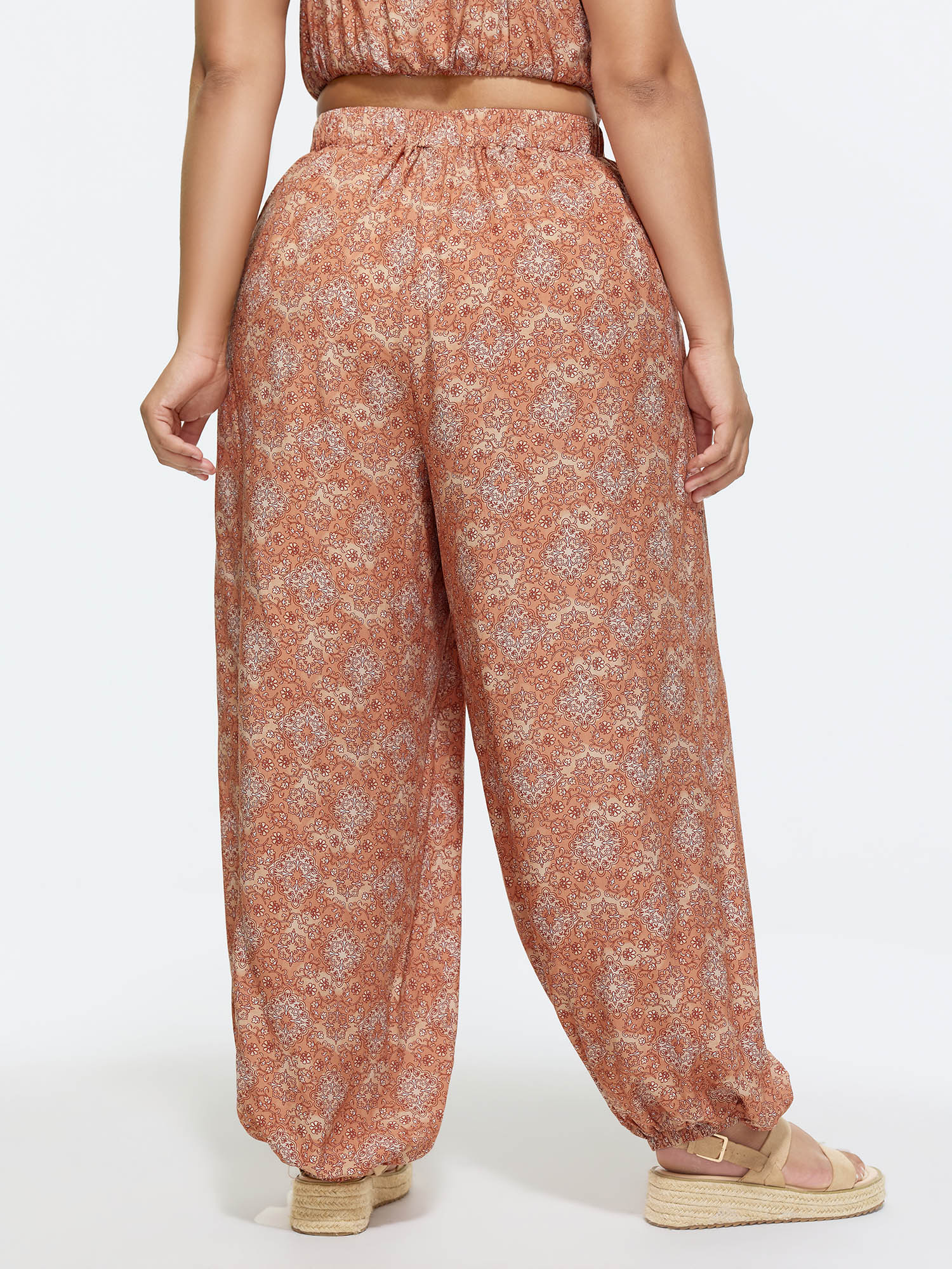Side view of BloomChic Women's Plus Size Boho Floral Print Elastic Waist Harem Pants Lightorange Ditsy Floral Wide leg Mid Rise Vacation 30/6X
