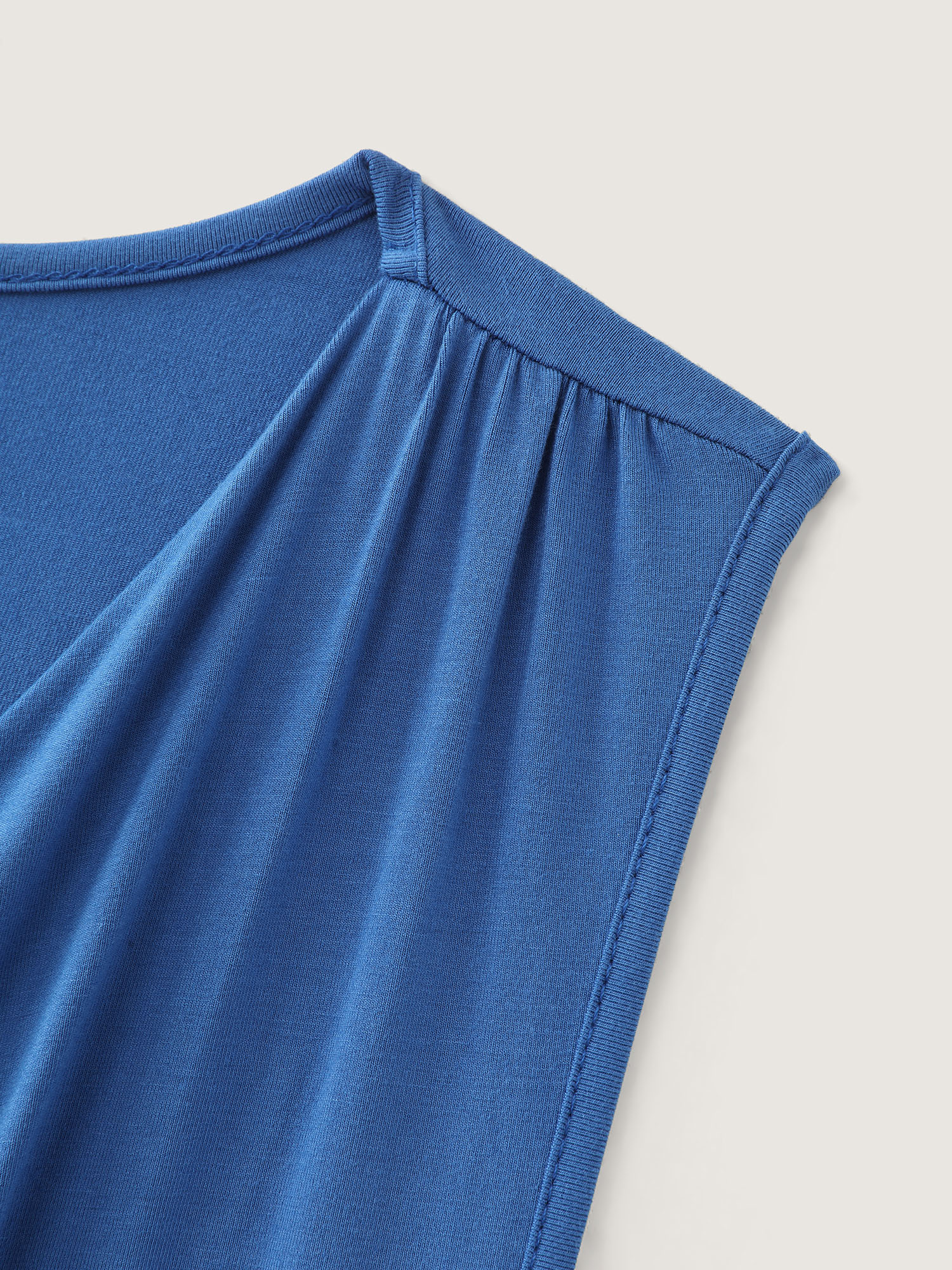 Side view of BloomChic Women's Plus Size Supersoft Overlap Stretchy Hem Tank Top Mediumblue Casual Cocoon V-Neck 30/6X