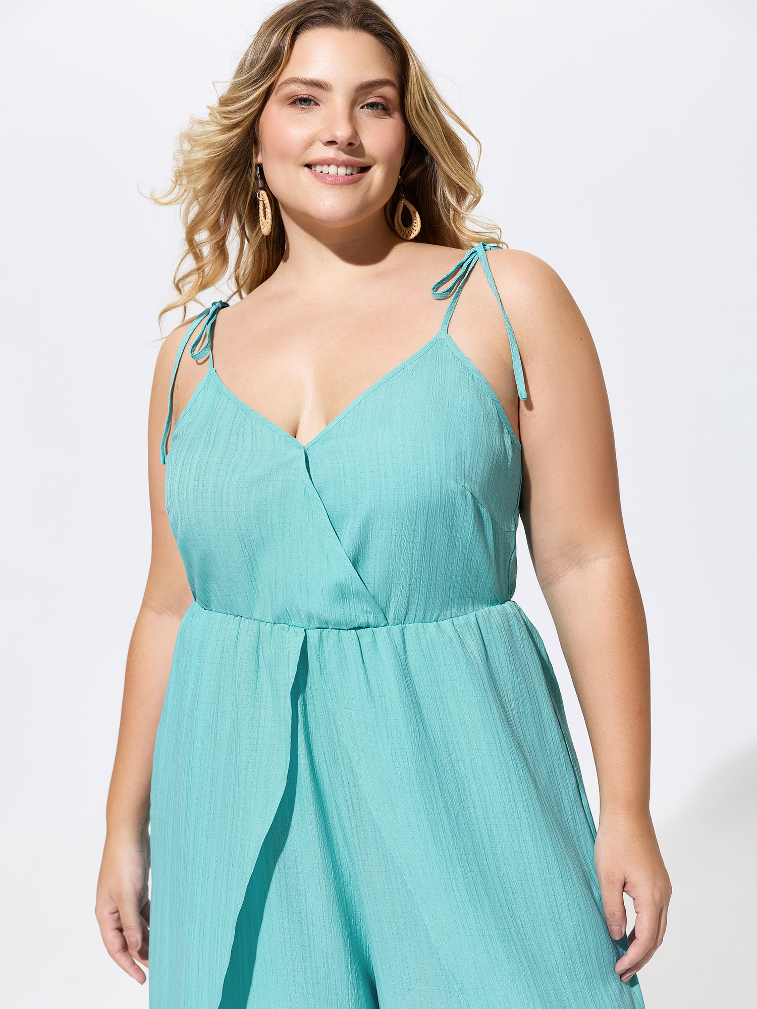 Side view of BloomChic Women's Plus Size Elastic Waist Petal Split Hem Jumpsuit Arctic Vacation 26/4X