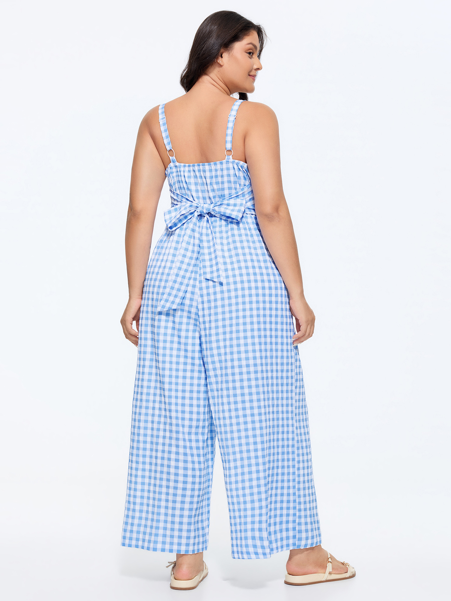 Side view of BloomChic Women's Plus Size Checkered Print Back Bow-Tie Jumpsuit LightBlue Casual 18-20/2X
