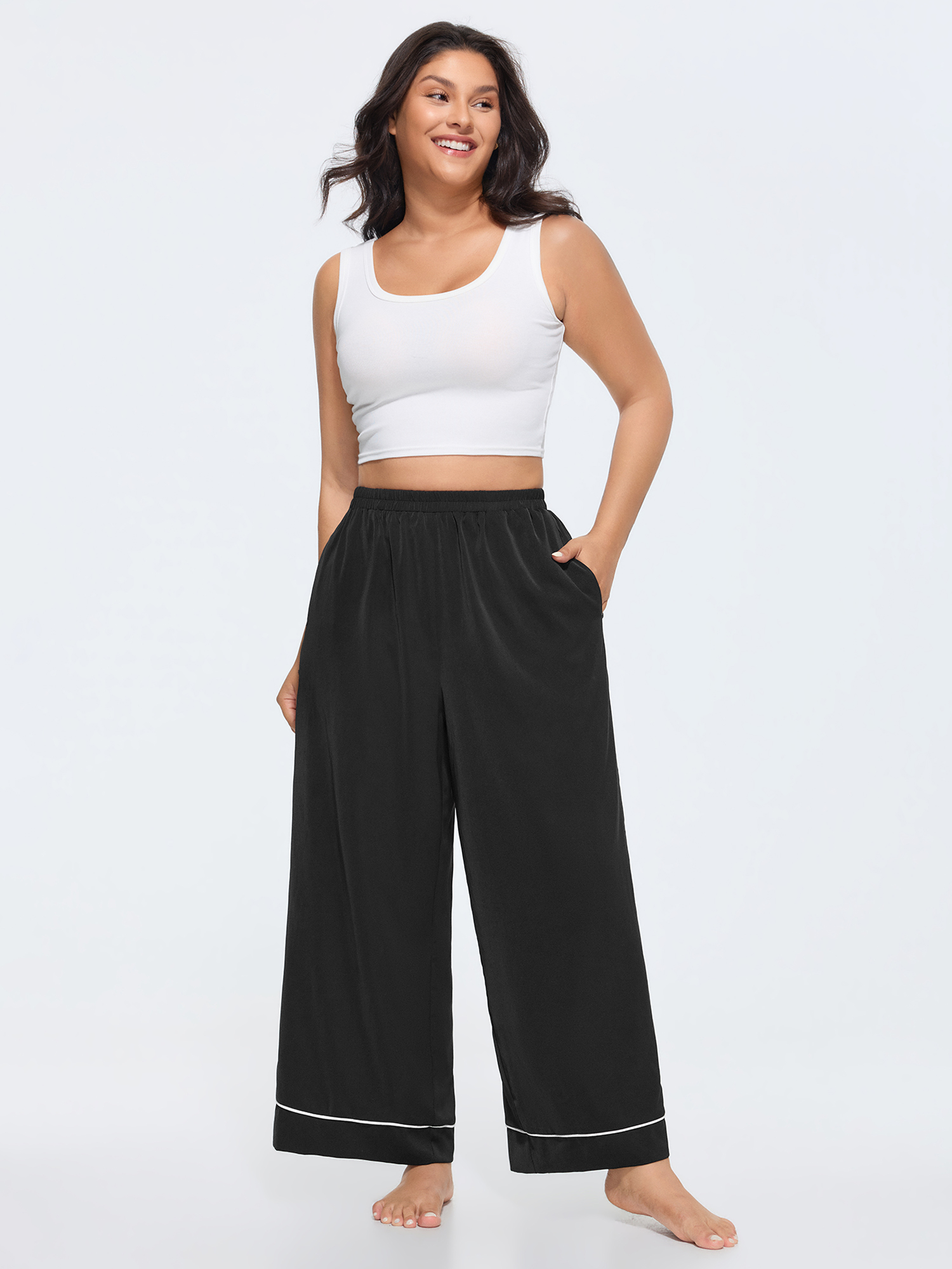 Side view of BloomChic Women's Plus Size Color Contrast Hem Straight-Leg Lounge Pants Black 14-16/1X