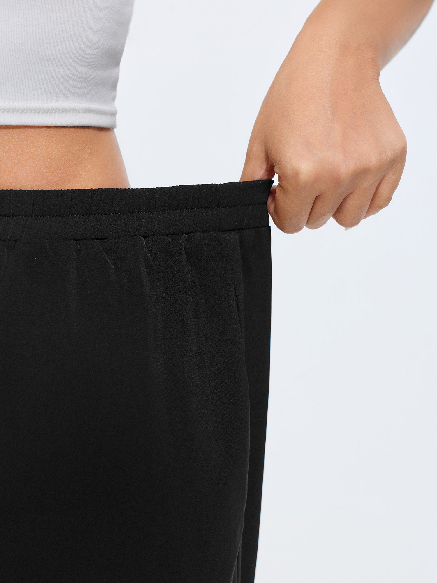 Side view of BloomChic Women's Plus Size Color Contrast Hem Straight-Leg Lounge Pants Black 14-16/1X