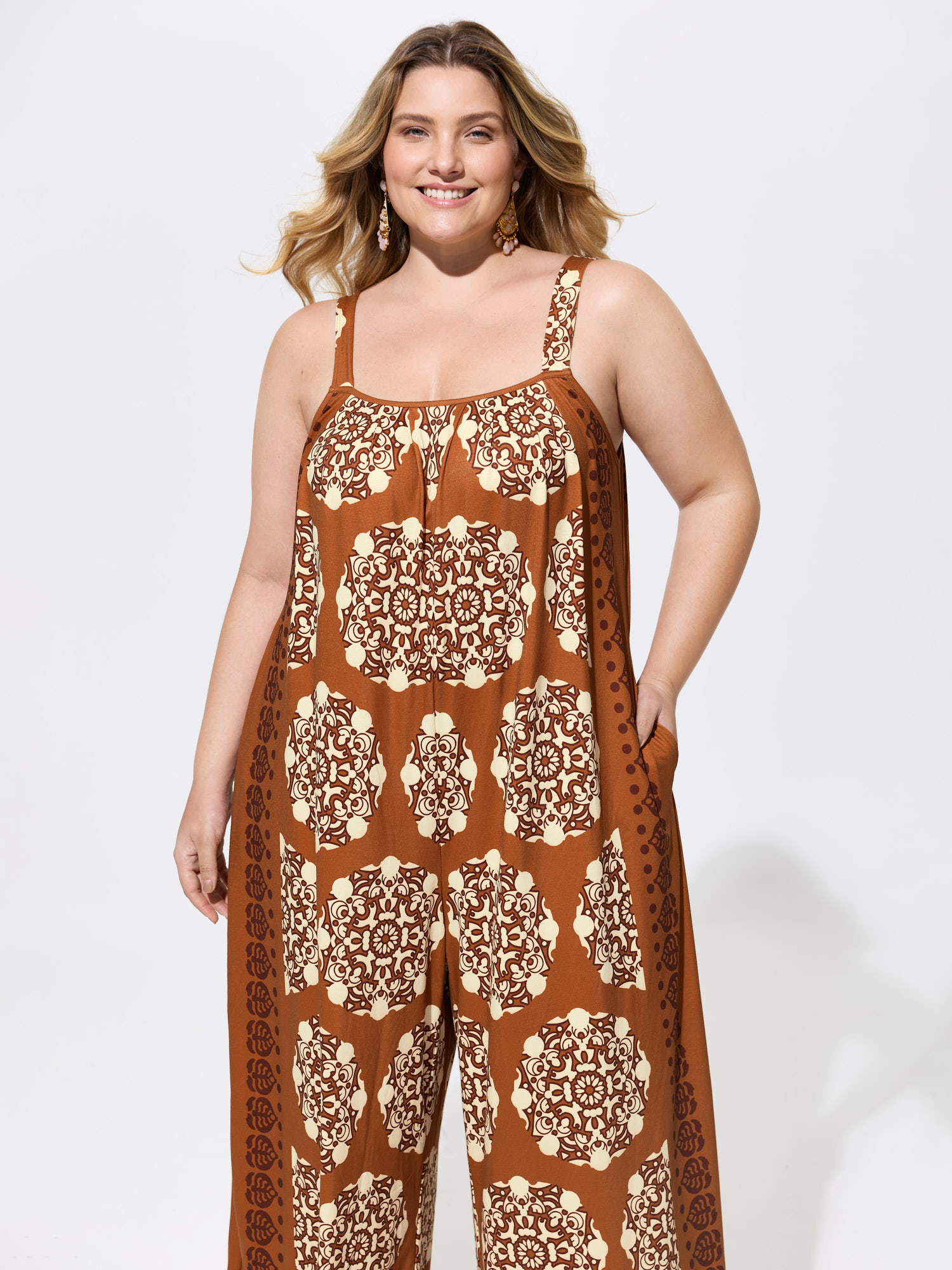 Side view of BloomChic Women's Plus Size Sunkissed Stretchy Adjustable Strap Jumpsuit Yellowishbrown Vacation Baggy 26/4X