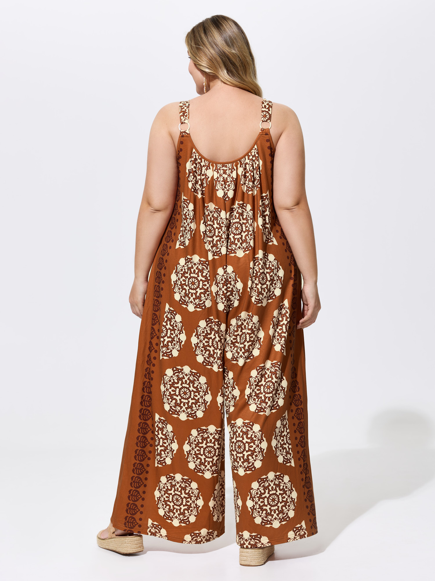 Side view of BloomChic Women's Plus Size Sunkissed Stretchy Adjustable Strap Jumpsuit Yellowishbrown Vacation Baggy 26/4X