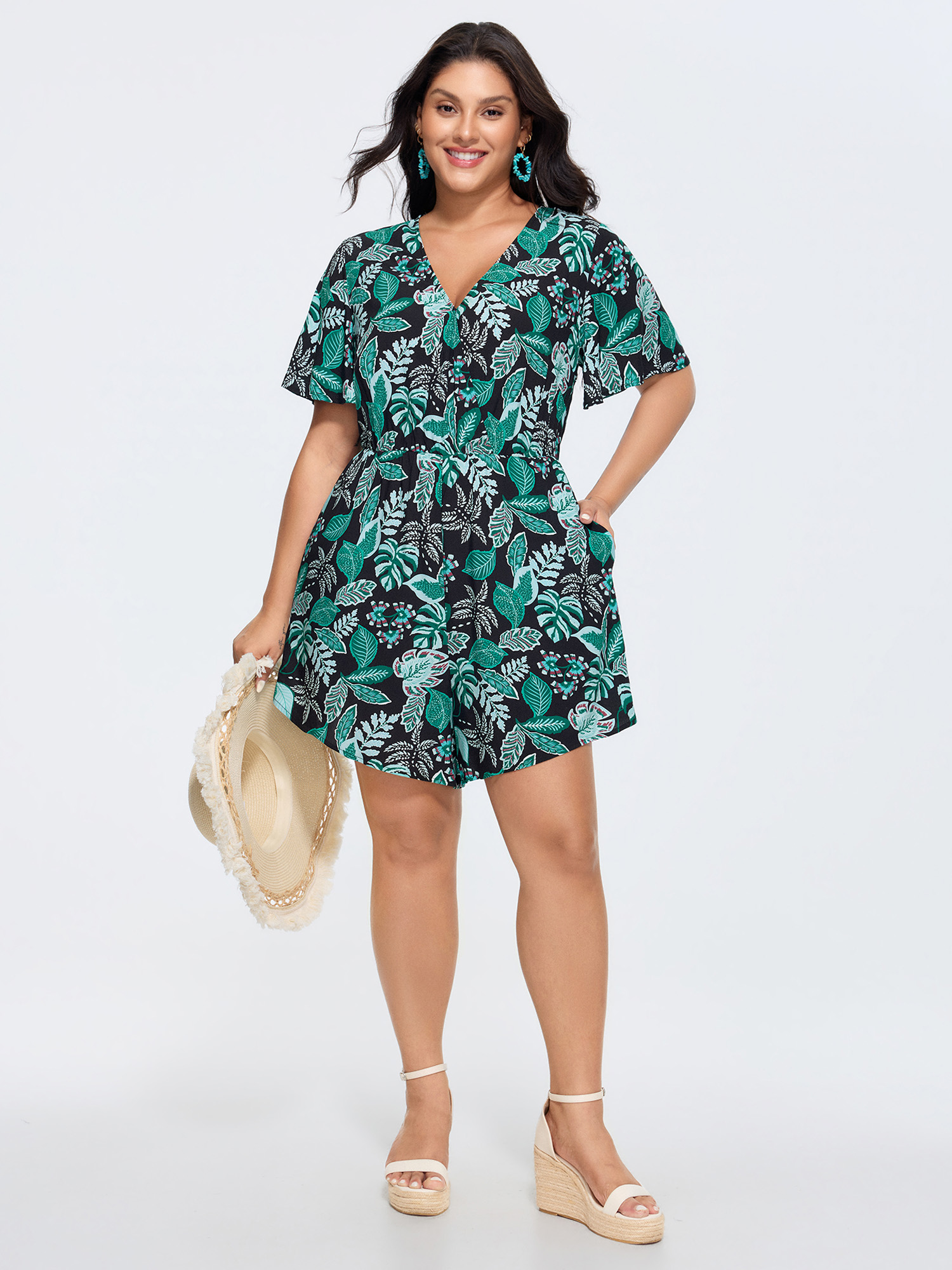 Side view of BloomChic Women's Plus Size Tropical Print Cut-Out Back Romper Black Vacation 14-16/1X