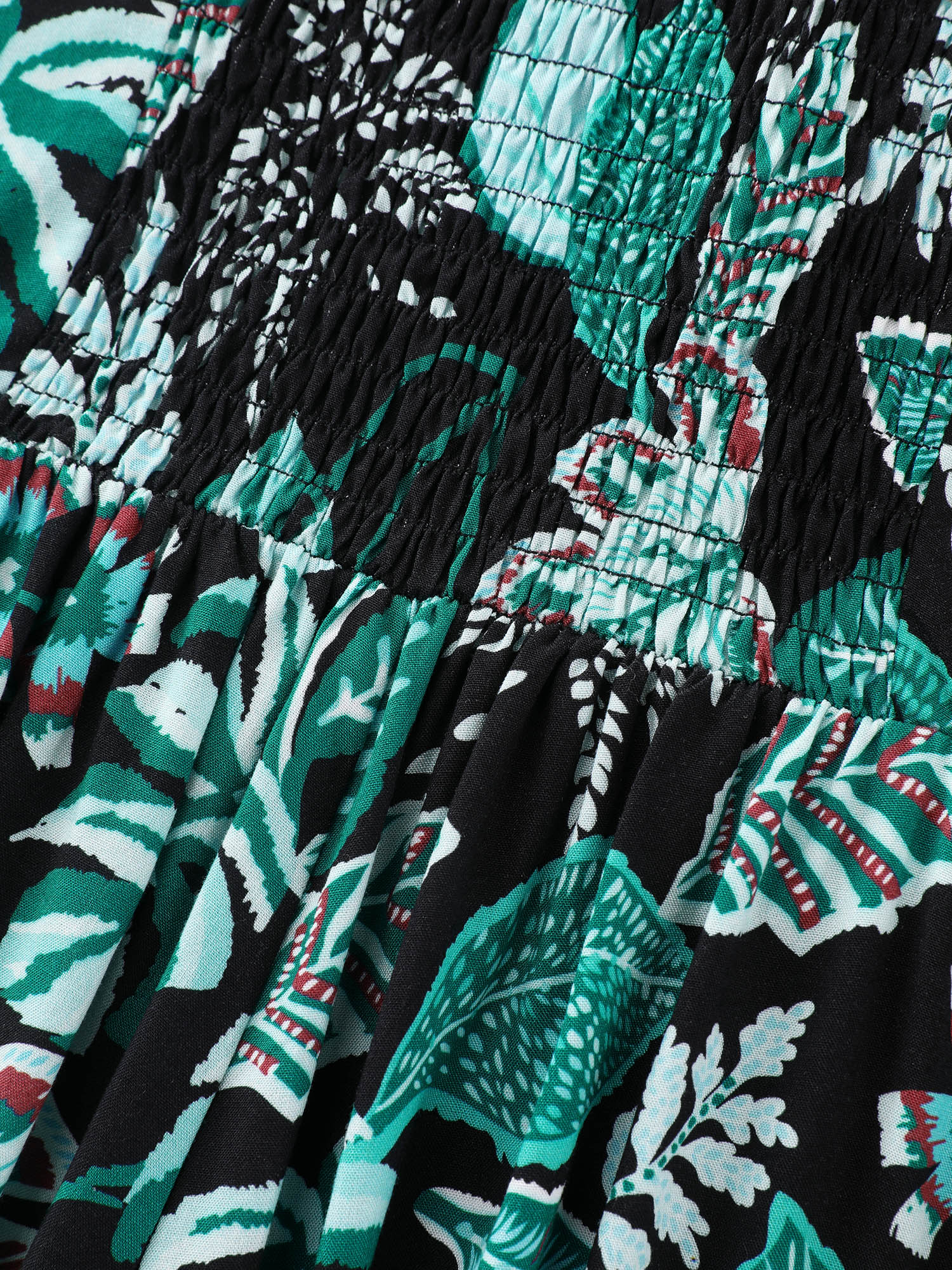 Side view of BloomChic Women's Plus Size Tropical Print Cut-Out Back Romper Black Vacation 14-16/1X