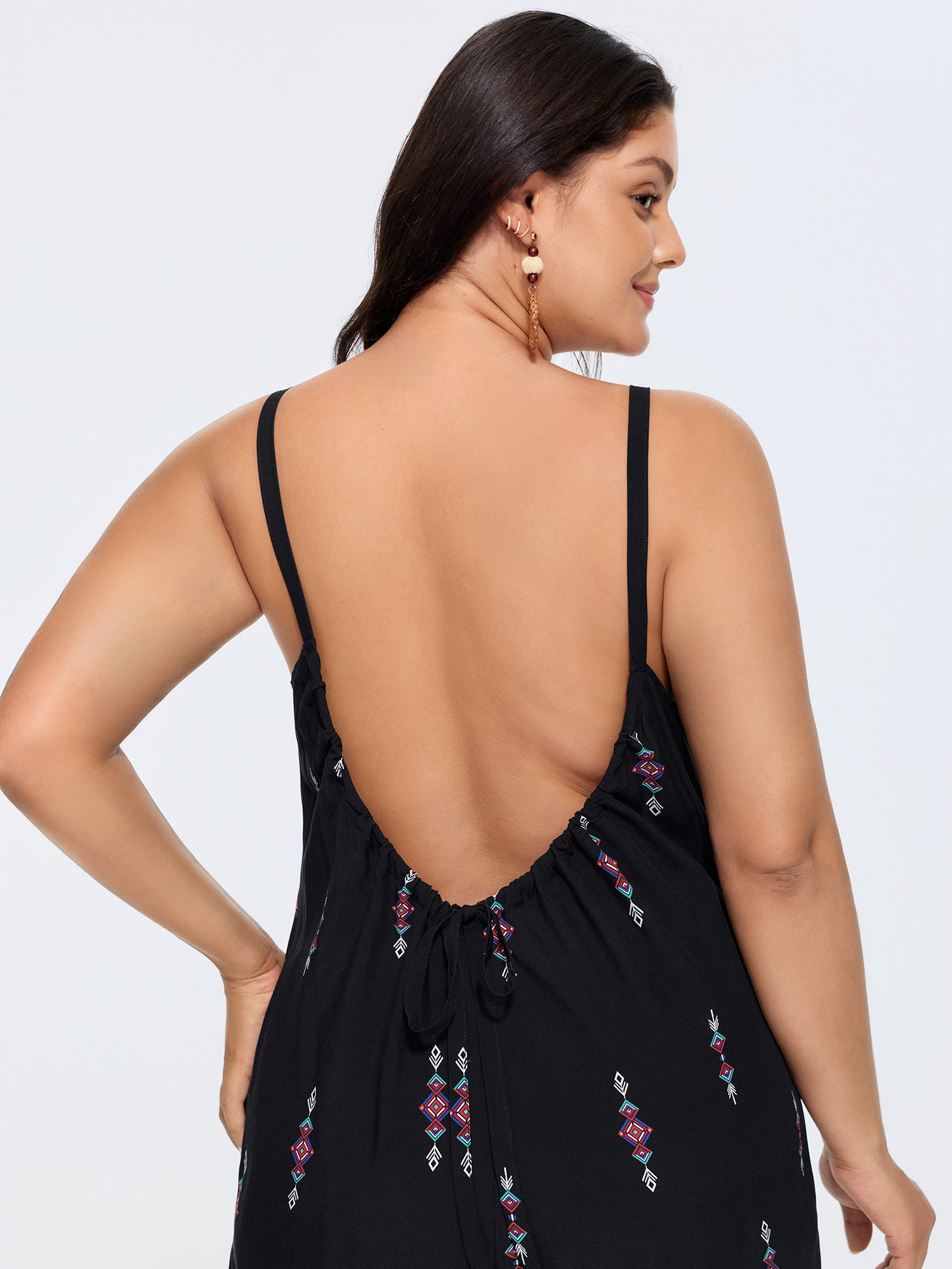 Side view of BloomChic Women's Plus Size Geometric Print Adjustable Backless Drawstring Jumpsuit Black Vacation 22-24/3X