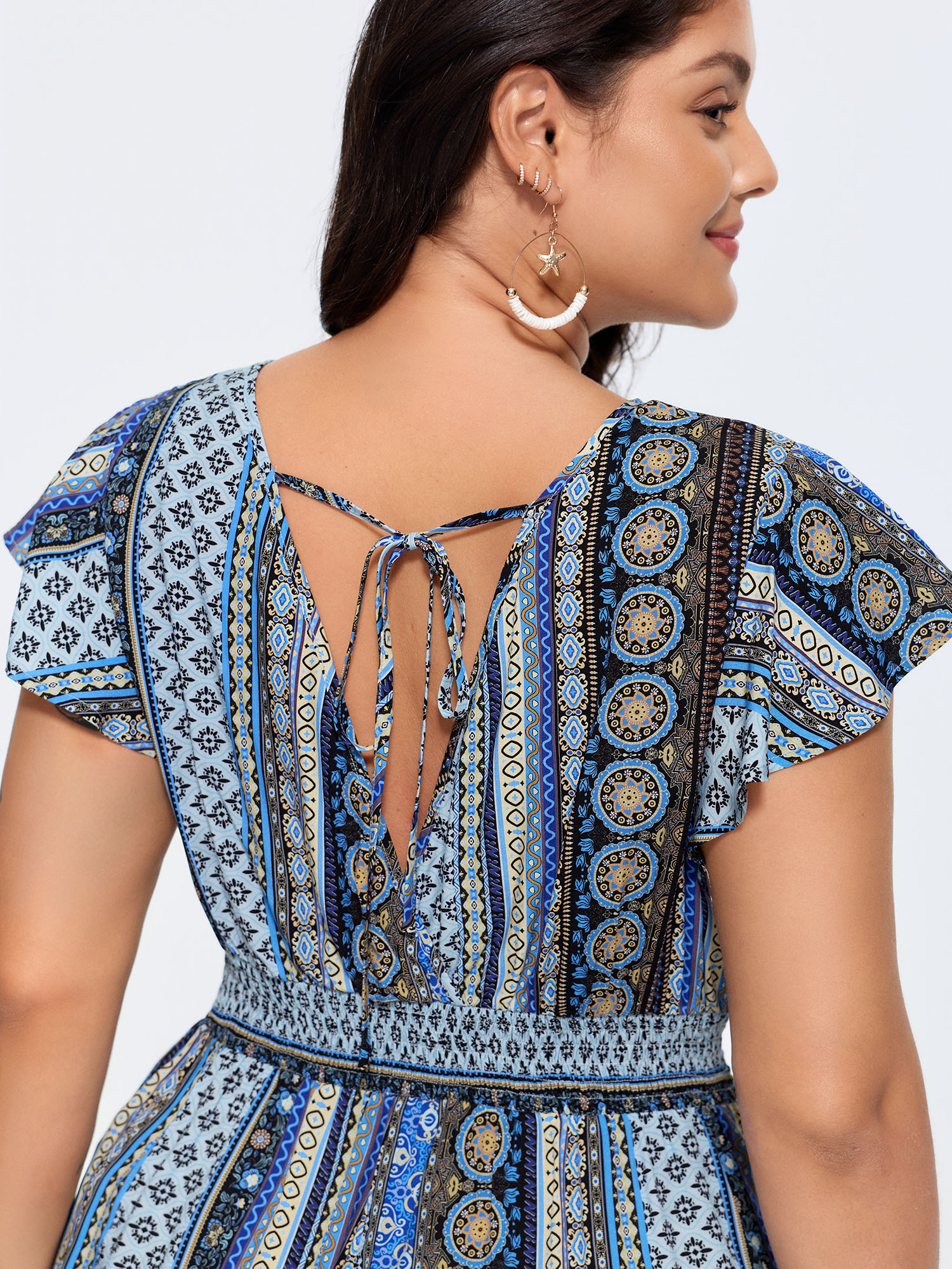 Side view of BloomChic Women's Plus Size Boho Striped Print Back-Tie Romper Multicolor Vacation 22-24/3X