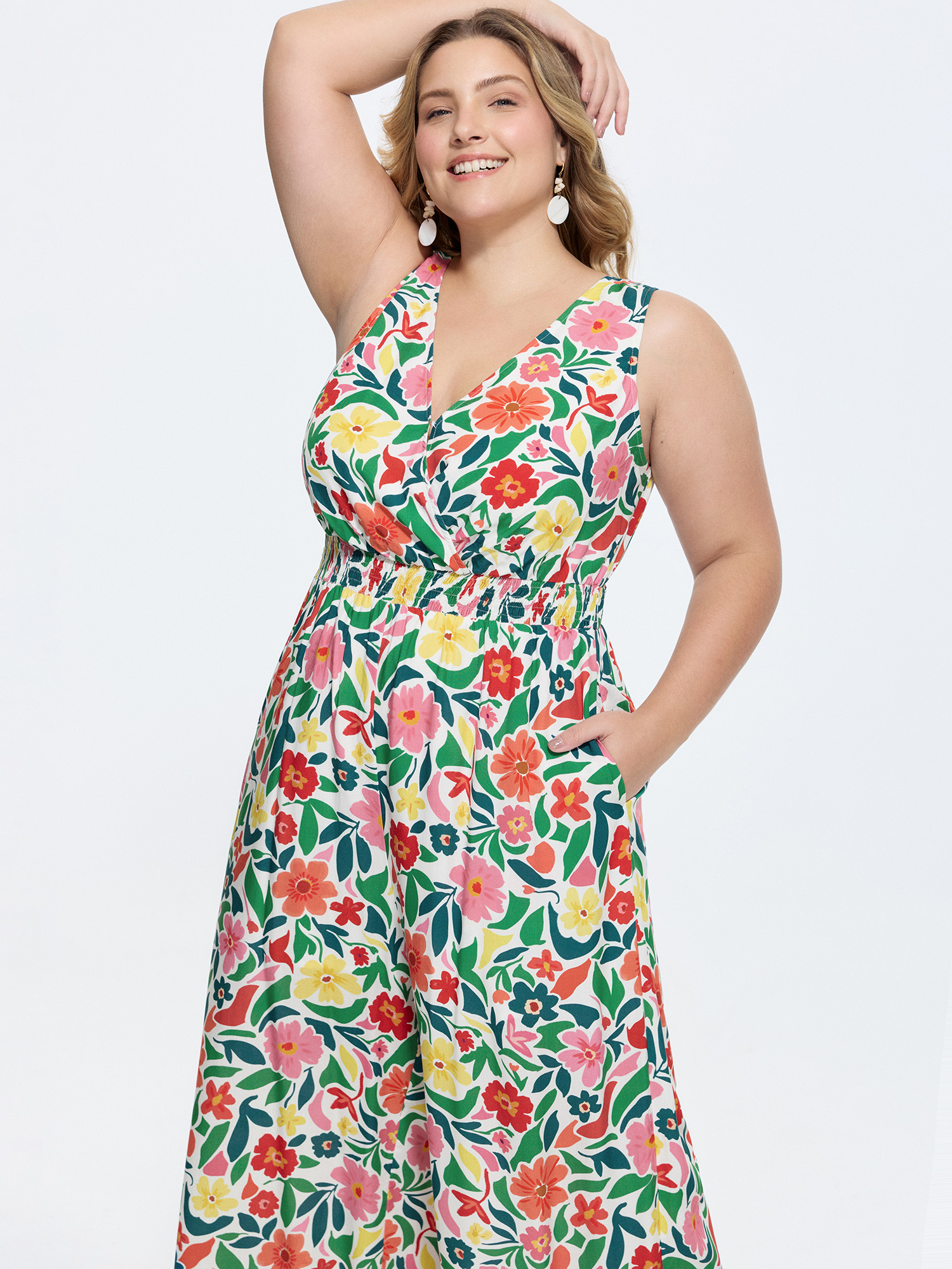 Side view of BloomChic Women's Plus Size Vibrant Floral Print Shirred Waist Jumpsuit Multicolor Vacation Relaxed Fit 26/4X