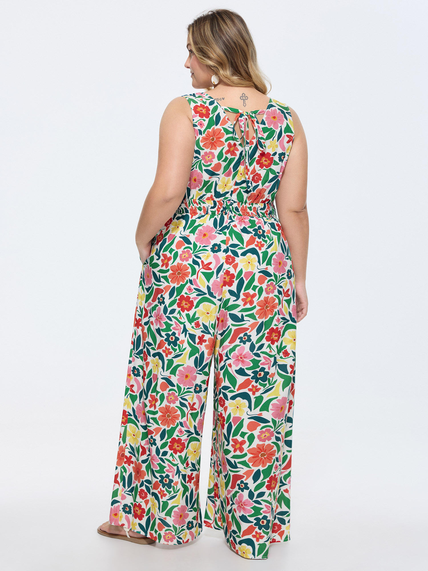 Side view of BloomChic Women's Plus Size Vibrant Floral Print Shirred Waist Jumpsuit Multicolor Vacation Relaxed Fit 26/4X